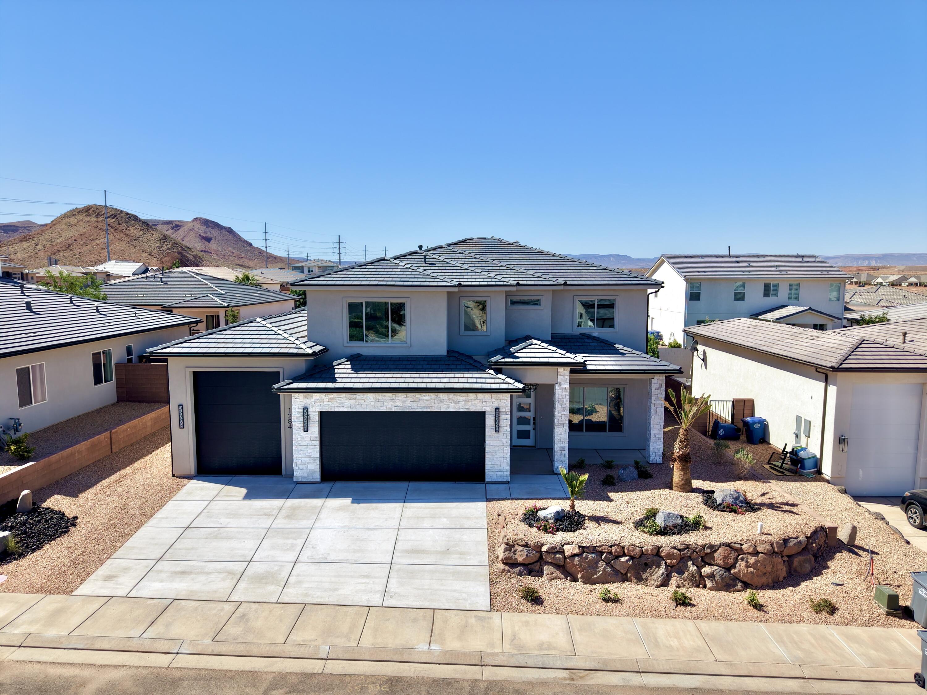 With its big beautiful windows this home was perfectly situated on the lot to take full advantage of its view corridors.  Completely finished yard, RV garage, office on main floor, Gourmet kitchen, designer tile and upgrades to finishes are all characteristics of this amazingly perfect home.  Centrally located to be close to all St. George has to offer.  Amenities offer a community pool and hot tub where you can relax and get to know your new neighbors!  This home sits on the last lot for a new build in the perfect Warner Gateway neighborhood.  Come take a look and be a part of the dream!.
