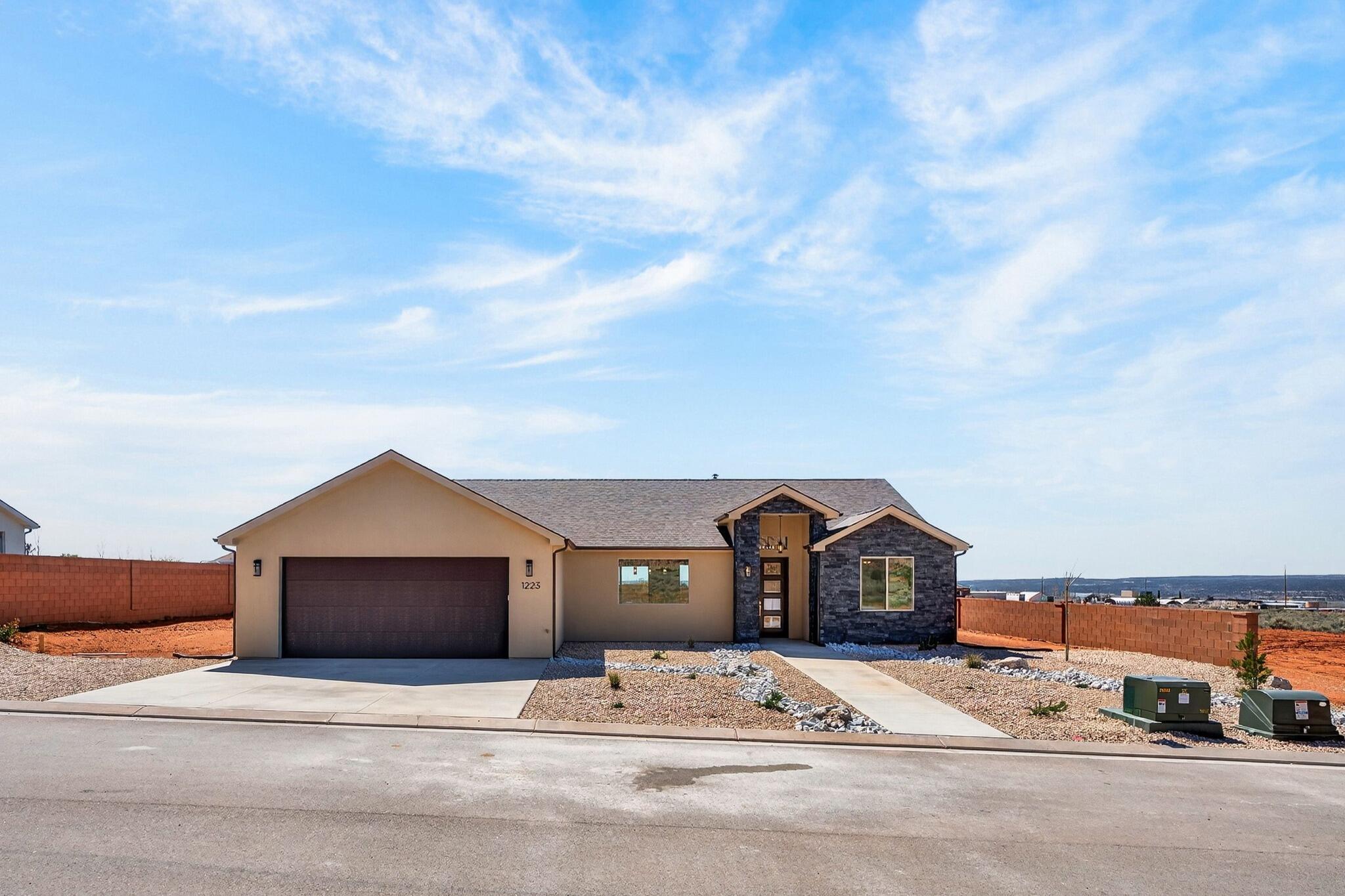 Introducing a stunning new home in the prestigious Heights Subdivision! This thoughtfully designed 3-bedroom, 2-bathroom home offers breathtaking red rock mountain views, a spacious 2-car garage, and RV parking for all your toys. The gourmet kitchen will include custom white cabinetry, quartz countertops, and oven range and dishwasher, perfect for cooking, baking, and entertaining. Upgraded lighting fixtures highlight the abundant natural light, while durable LVP flooring flows through the main living areas and cozy carpet creates comfort in the bedrooms. The vaulted primary suite is a true retreat, with windows framing gorgeous views and a luxurious ensuite featuring dual vanities, a designer shower, and a relaxing soaker tub. Outside, the partially landscaped yard with fencing provides a private oasis for family, pets, and gatherings. Nestled at a 5,000 ft elevation, this home is surrounded by stunning terrain and a favorable climate. Located just off the edge of town, you'll be close to riding and hiking trails, 5 National Parks, Sand Dunes, and within a short drive to Lake Powell (90 minutes), the Grand Canyon (60 minutes), Zion (45 minutes), Kanab (30 minutes), and St. George (40 minutes). Make this extraordinary home yours today.**Seller financing is an option with 20% down**