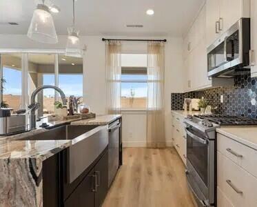 Model Home!! Featuring the Crimson DM + Balc floor plan, thoughtfully designed and built by Carefree Homes-Southern Utah's trusted builder. Carefree delivers service that exceeds our home buyers expectations before, during and after the sale! Conveniently located near major highways and just minutes from exciting new commercial developments, this home is perfect for both work and leisure. Highlights include durable 2x6 construction, stylish 2'' faux wood blinds, epoxy-coated garage floors, a fully landscaped yard, quartz/granite countertops, and soft close drawers. All info to be verified by buyer and buyers agent. Furniture not included. Nestled within a vibrant and growing community, you'll enjoy a wealth of amenities right at your doorstep, including a state-of-the-art lagoon and all year long heated pool with several pickleball courts, perfect for outdoor fun and relaxation with family, friends and neighbors. Call today for a showing or for more information about Southern Utah's unique community, Desert Color.