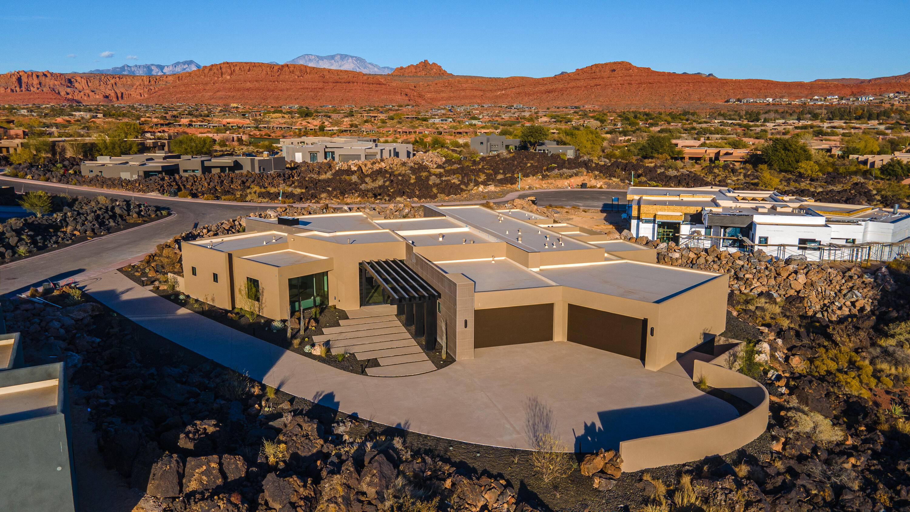 Perfectly situated among basalt rocks at the base of Snow Canyon inside Entrada Golf & Country Club, this brand-new custom home captures stunning red rock and mountain views. The great room features a striking fireplace wall, expansive windows, and views of a private backyard with heated pool, spa, outdoor fireplace, built-in BBQ kitchen & TV hookups. The chef's kitchen offers Riverwoods Mill cabinets, Wolf/Subzero appliances, waterfall island, butler's pantry, and hardwood floors. The primary suite includes a luxury bath, gym, spacious closet with W&D and private patio access. Additional features: office, casita, ensuite bedrooms, 4-car garage w/ EV charger, Crestron Home automation, motorized shades, solid wood doors and so much more! 
Buyer to verify all information.