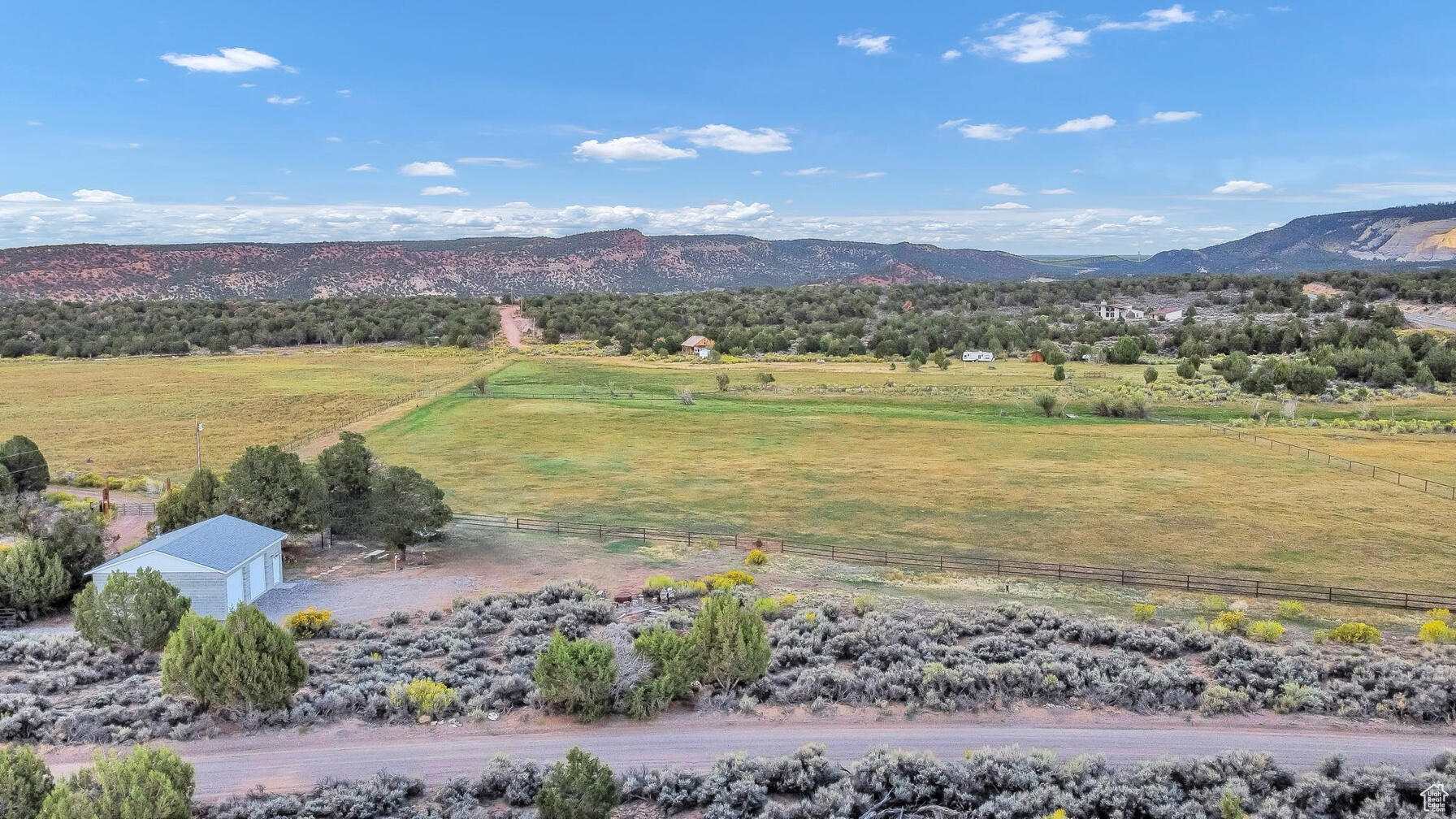 An unmatched piece of land and turn key property in rural paradise in Grover, Utah. Located just minutes from the iconic Capitol Reef National Park, this stunning 6.24-acre property offers an incredible blend of natural beauty, functionality, and freedom. Surrounded by panoramic views of sweeping pastures, red rock cliffs, and open skies, this land is truly one of a kind. With 5.24 acres of lush, sub-irrigated pasture enrolled in greenbelt, it's ideal for horses, cattle, or agricultural use. The property is fenced with steel pipe fencing for your animals. A well-built 952 sq. ft. shop, complete with a wood-burning stove, provides ample space for tools, toys, or future expansion. Power is connected, and the property is equipped with a private well, septic system, and full RV hookups, making it ready for immediate use. Whether you're looking to build your dream home, establish a small ranch, or enjoy it as a peaceful retreat, this land offers unmatched versatility. With no HOA and the potential to subdivide, the possibilities are endless. Enjoy the tranquility of rural living without sacrificing access to some of Utah's most stunning outdoor adventures. Don't miss your chance to own this panoramic slice of paradise! Properties like this rarely come available.