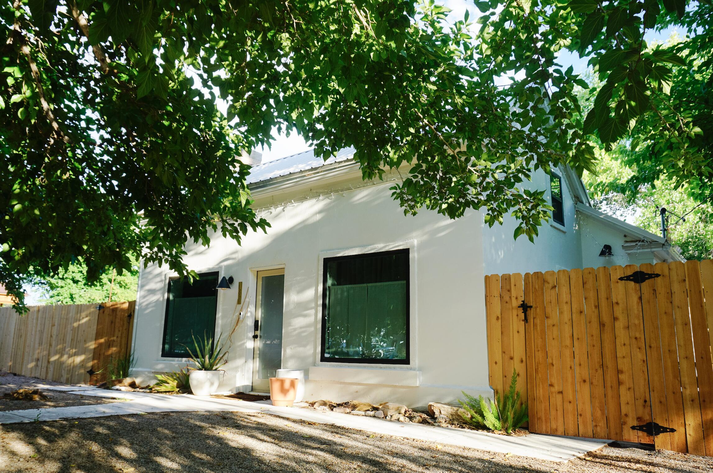 Designer style meets authentic Southern Utah history.
Nestled beneath mature trees on a generous corner lot, this one-of-a-kind home beautifully blends timeless design with authentic pioneer character. The original pioneer portion of the home dates back to the late 1800s, thoughtfully expanded in the 1920s, creating a home that simply couldn't be recreated today.
Completely reimagined in 2022, every space was thoughtfully designed to preserve the home's soul while bringing it into modern life. Rich original hardwood floors, abundant natural light, carefully selected finishes, and a warm, elevated aesthetic make every room feel both inviting and intentional. It's the kind of home that feels as beautiful as it is livable.
Behind the character is the confidence of extensive updates, including all new electrical and plumbing, a new roof, new windows, mini-split heating and cooling throughout, and countless other improvements that allow you to enjoy the charm of a historic home without sacrificing modern comfort.
Situated on a spacious .24 - acre corner lot in the heart of Washington City, you'll enjoy a quiet, established neighborhood just minutes from parks, restaurants, shopping, schools, and everything Southern Utah has to offer. Whether you're enjoying coffee beneath the mature shade trees, entertaining friends, or heading out to Zion National Park, Sand Hollow, or Snow Canyon, this home offers a lifestyle that's as unique as the home itself.
Homes with this level of character are incredibly rare. Beautifully designed, thoughtfully renovated, and deeply rooted in Southern Utah's history, this is more than a house, it's a home with a story