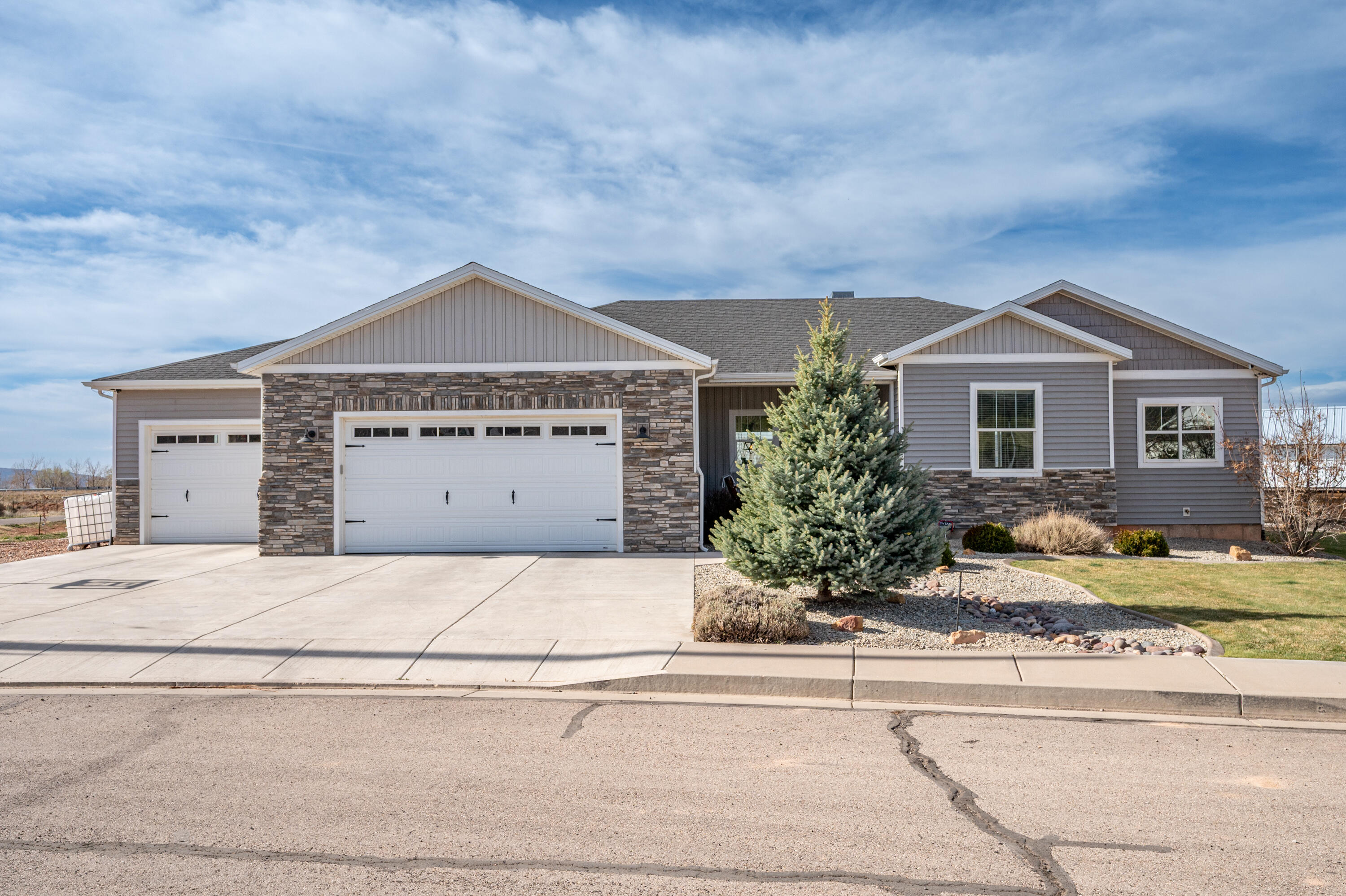 Beautifully upgraded custom home on just over 1/2 acre with room to live, relax, and enjoy! Featuring a warm woodburning fireplace, granite countertops, tons of cabinetry, and a spacious walk-in Butler's pantry. Main level living includes the primary suite, living room, kitchen, and laundry for ultimate convenience. The primary suite offers barn doors, a luxurious bathroom with soaking tub, separate walk-in shower, and dual vanities. Oversized 3-car garage with a 32-ft deep third bay, plus RV parking with power. Outside you'll find a metal shed and raised garden beds. A must-see property with space, style, and functionality!