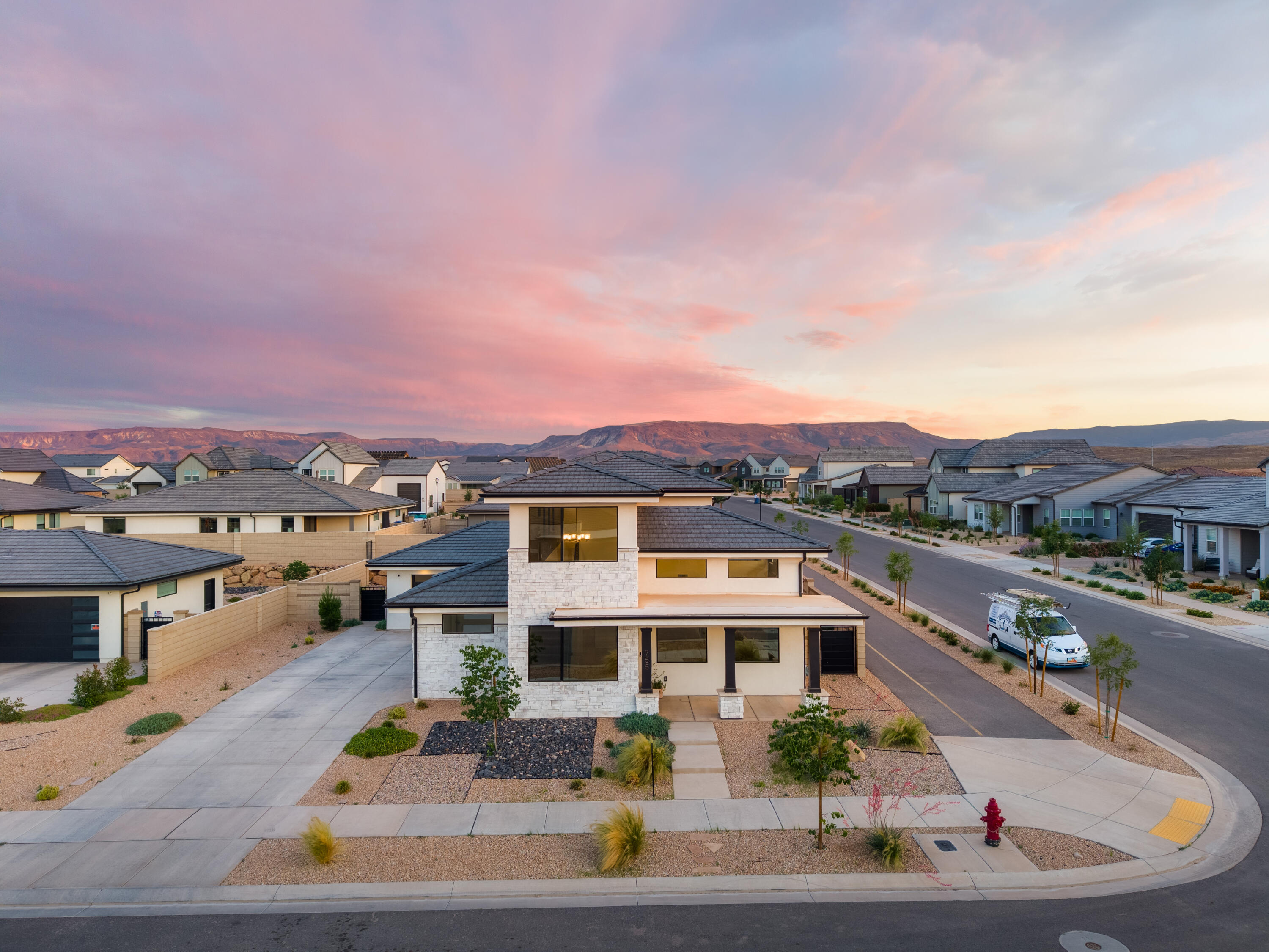**MOTIVATED SELLER***Experience resort-style living at its finest in this stunning, smart-wired home located in the highly sought-after Desert Color community. Perfectly positioned on a desirable corner lot, this 5-bedroom, 2.5-bathroom retreat offers an open-concept design with soaring ceilings, huge windows that flood the space with natural light, and breathtaking mountain views. The chef's kitchen features custom cabinetry, beautiful accent walls, and a spacious island. The primary suite is conveniently located on the main level and boasts a grand spa-like bathroom. Designer details throughout include gorgeous draperies, stylish finishes, and thoughtfully curated spaces. The 3-car garage has room for all your adventure gear, whether it's paddleboards for the lagoon, bikes for exploring community trails, or extra toys. Just steps from your door, you'll find the spectacular Desert Color Lagoon, clubhouse, pools, spa, and pickleball courts, making this one of the best locations in the neighborhood. Living here means enjoying: Sparkling pool & sandy lagoon with cabana and paddleboard rentals, multiple pickleball courts & beach volleyball, scenic bike paths & green spaces, playgrounds, gathering areas, and an active community vibe, BIG SHOTS golf only minutes away! This home perfectly blends comfort, energy efficiency, and an unbeatable location, offering the ultimate Southern Utah lifestyle in one of St. George's most desirable communities.