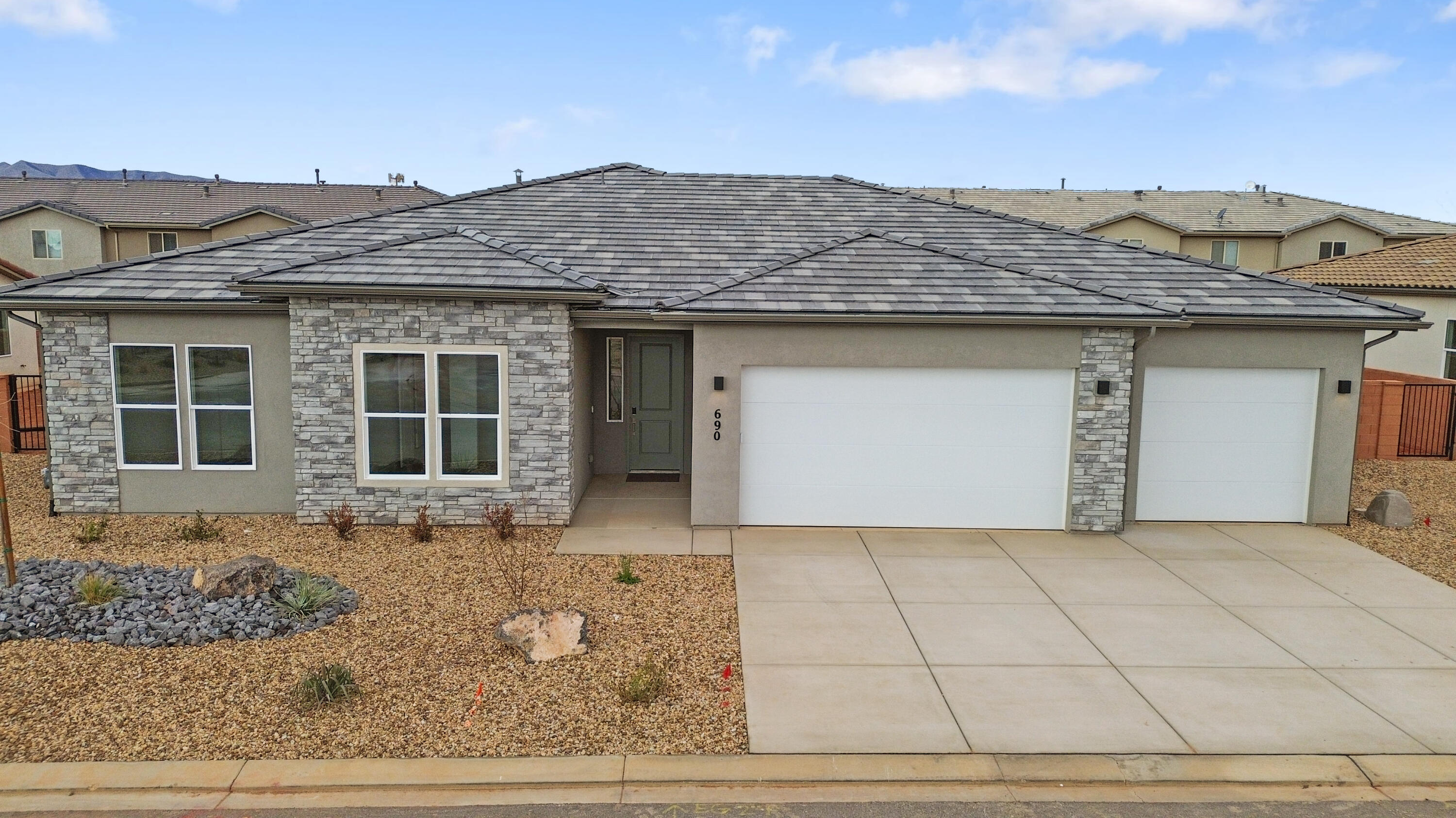 Interest Rates as low as 3.99% available through our preferred lender. Surrounded by beautiful desert and red rock scenery. Fire Lake at Ivins Reservoir, Unity Park, and Kayenta Art Village are very close by. A short drive away are Tuacahn Ampitheater, Snow Canyon State Park and Black Desert Golf Course and resort. This floorplan has a sunroom extension off the large kitchen. Enjoy a gourmet kitchen, quartz countertops throughout, a fireplace in the great room, and a shady covered patio. The 3rd car garage bay is double deep so there is room for all the cars and toys.