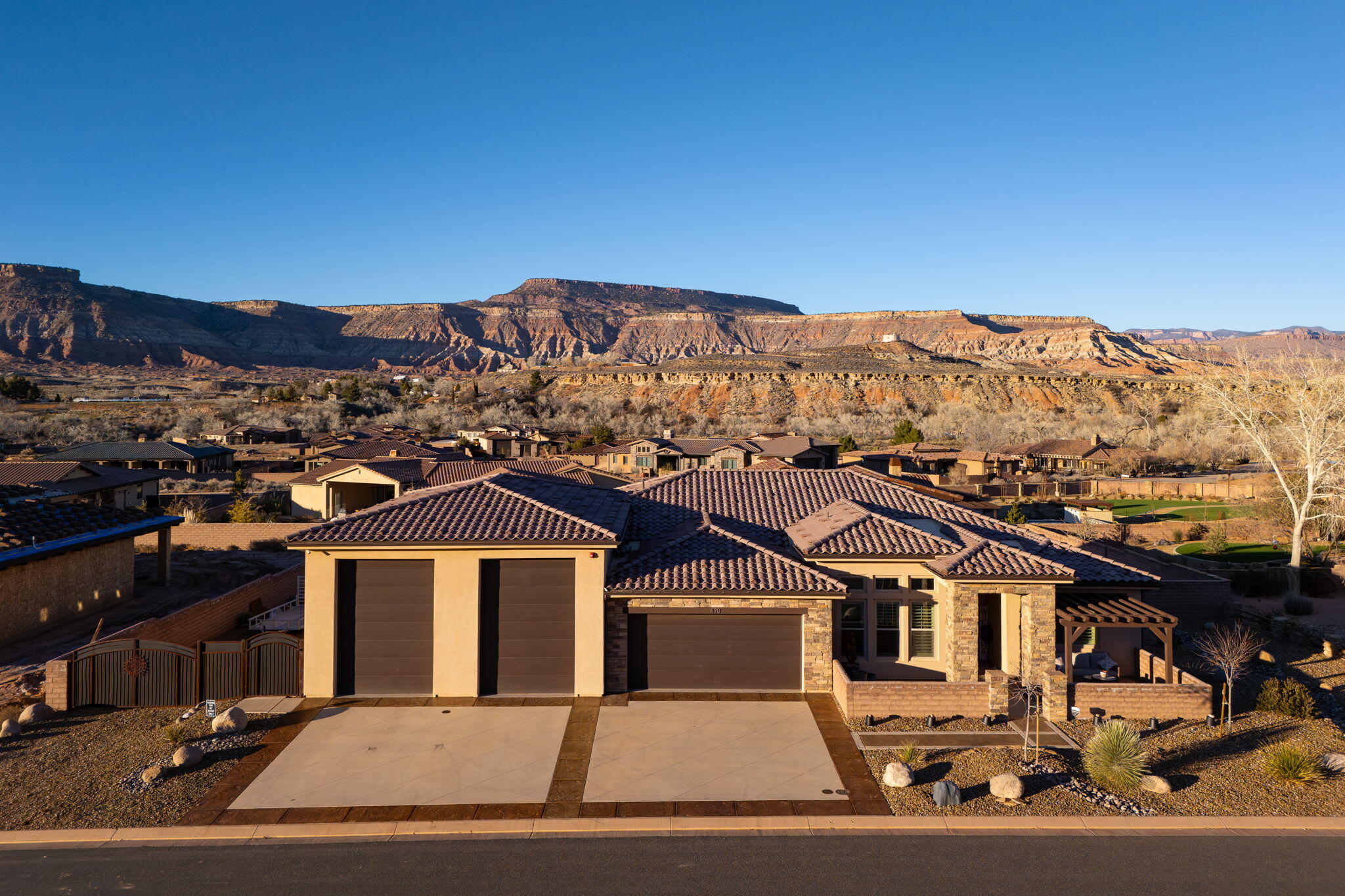 Welcome to 470 E Entrada Dr, where refined desert luxury meets exceptional tranquility in the sought-after Rio De Sion community of Virgin, Utahjust 10 minutes from Zion National Park. Set on a spacious half-acre lot, this thoughtfully designed single-level home balances comfort, elegance, and a seamless connection to the surrounding desert landscape. With 4 bedrooms and 4 bathrooms, the layout and finishes create a serene retreat you'll truly enjoy coming home to.

At the heart of the home, you'll enjoy an open-concept great room with coffered ceilings, hardwood floors, stunning built-in shelves, and a cozy fireplace, creating an inviting space for both everyday living and entertaining. The gourmet kitchen is designed to impress with top-of-the-line appliances, quartz countertops, custom cabinetry, a large island, and a sleek hidden pantry, blending beauty and function with ease.(
You'll appreciate the elevated construction and design details throughout, including insulated interior walls for sound control, hardwood and custom tile flooring throughout, plantation shutters and custom blinds, customized indoor and outdoor lighting, an integrated indoor/outdoor surround sound system, and an 8-camera security system, all contributing to comfort, privacy, and peace of mind.(
The primary suite offers a calming escape where you'll unwind in a spa-inspired bath with dual vanities, a soaking tub, walk-in shower, and a generous walk-in closetperfect after a day exploring the surrounding red rock landscapes.(
Step outside to your private desert oasis, where you'll enjoy meticulously xeriscaped landscaping, a saltwater pool, and an expansive patio designed for relaxation and entertaining. As evening settles in, you'll be captivated by the panoramic views of Zion National Park, the Kolob Terrace, and the iconic horizons of Smith Mesa, along with the rare beauty of brilliant starlit skies overhead. With a garage accommodating up to six vehicles, you'll have ample space for cars, adventure gear, and everything Southern Utah living inspires.(
Surrounded by dramatic mesas and endless desert beauty, 470 E Entrada Dr offers a rare opportunity to experience luxury, serenity, and the very best of Southern Utah living.