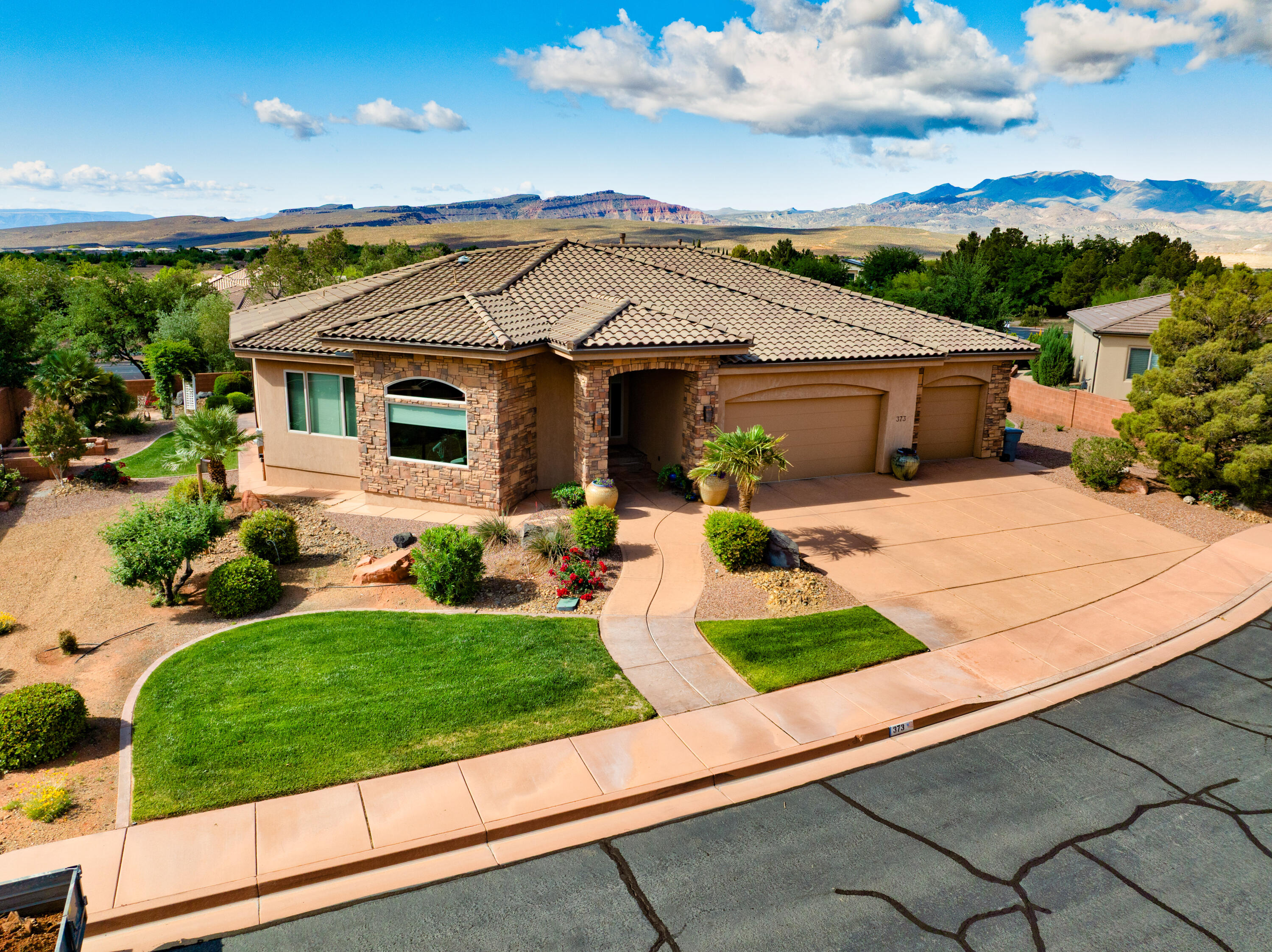 Glorious views of Red Mountain and the majestic cliffs are enjoyed from this pristine custom home!  From the grand entry to the spacious living area, perfect for entertaining.  A large office with views just off the entry.  The kitchen, a chef's delight, with custom cabinets and pull out shelving, an abundance of granite counter space and a large pantry.  Relax in the great room around a cozy fireplace and gather at the dinner table with ample room.  A large master suite with views, a walk-in closet with built-in drawers, large walk-in shower and a free standing soaker tub.  Two guest rooms and a bathroom also on the main floor.  Solar tube lights in the stairwell to the downstairs where you'll find a huge great room/theater, 2 guest rooms, a full bath, 2 large storage rooms and a kitchenette.  All this with an oversized 3 car garage situated on a .35 acre lot in Ivins, 1 mile from Tuacahn Amphitheater, Black Desert Resort and the new PGA golf course!
