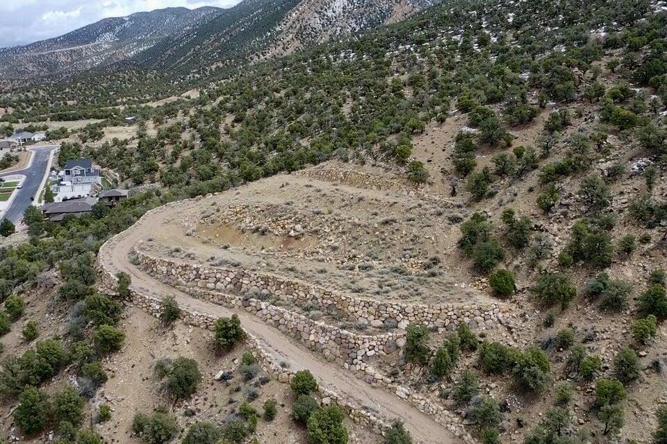 1.83-acre west-facing view lot in the highly desirable Ashdown Forest community, offering panoramic views of Cedar City and the surrounding mountains. Private drive leads to a prime build site with endless potential for a custom home, outdoor living spaces, and additional structures such as a shop or RV garage. Located in a quiet, established neighborhood with access to trails, nearby amenities, and outdoor recreation. A rare opportunity to build in one of Southern Utahs most scenic settings.