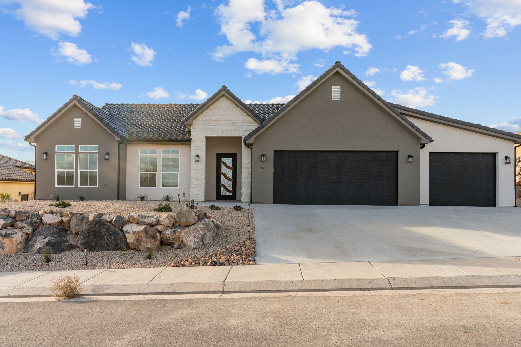 New Construction- MOVE IN READY! No HOA with Casita! Enjoy single level living (no stairs) 4 Bedroom | 3 Bath | 3 Car Garage. The main home offers 3 bedrooms and 2 baths (2,000 sq ft), plus a private 1 bed, 1 bath casita (546 sq ft) with full kitchen, laundry hookups, and separate entrance—ideal for guests, rental income, or a home office. Home Features: gas fireplace, custom cabinetry throughout, tile baths, and a spacious primary suite with a walk-in shower and large closet. Relax on the oversized covered patio with a spacious backyard and extra RV parking—just minutes from Sand Hollow lake, sand dunes, golf, and Zion National Park. This home offers practical living with a luxury feel. Perfect for First Time Home Buyers, 2nd Home or an ADU option for extra rental income to offset costs.