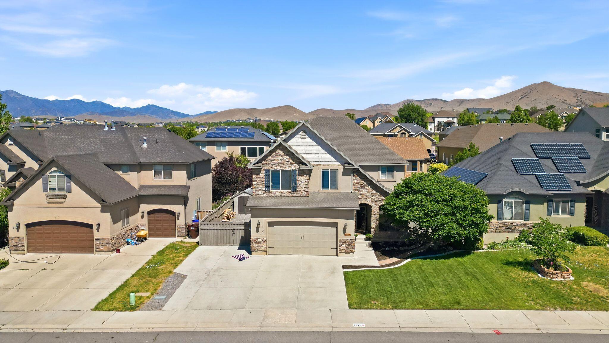 Ideally situated near the golf course and surrounded by beautiful mountain views, this spacious home offers the perfect blend of comfort and convenience. The bright, open floor plan features a modern white kitchen with an oversized island, abundant cabinetry, and seamless flow into the dining and living areas, making it ideal for everyday living and entertaining. The generous primary suite includes a beautifully updated spa-inspired bathroom with a freestanding soaking tub, walk-in shower, and large closet. Downstairs, the finished basement provides a second family room and additional living space for guests, recreation, or movie nights. Outside, enjoy the covered patio and fully fenced backyard with plenty of room to relax, play, or create your dream outdoor retreat.