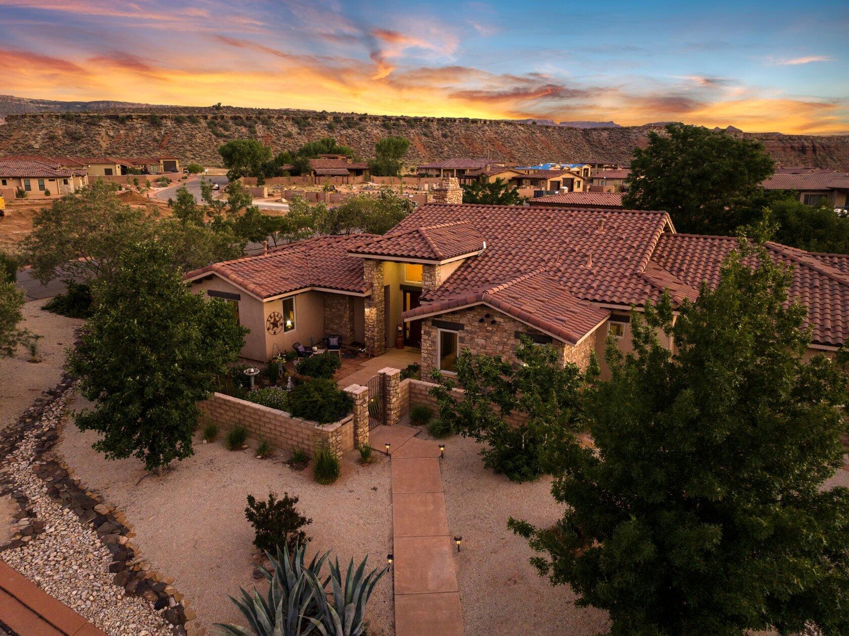 Nestled on over half an acre in the charming town of Virgin, Utah--just moments from the splendor of Zion Canyon--this custom-built residence offers a refined blend of indoor comfort and outdoor beauty. Beyond the private gate, a new privacy block wall and a landscape of fruit and nut trees, raised garden beds, and curated desert flora invites you to slow down and savor the seasons. Whether you're harvesting fresh figs for a summer tart or gathering herbs for a winter roast, the land here is as purposeful as it is picturesque. Inside, the 2,466-square-foot floor plan is graciously laid out, featuring three spacious bedrooms and three bathrooms--including two generous primary suites designed for rest and rejuvenation. High ceilings, natural light, and quality finishes throughout create a warm, welcoming atmosphere perfect for both quiet evenings and festive gatherings.

The oversized garage including a separate workspace and storage room, provides ample space for storage and hobbies, while the nearby trails and canyons offer endless opportunities for exploration. Whether you're preparing fresh pasta in the well-appointed kitchen or enjoying morning tea on the patio with views of red rock cliffs, every moment in this home is a celebration of comfort, style, and simple pleasures.

*Sellers circumstances have changed-All offers will be reviewed and responded by 5/5/2026.