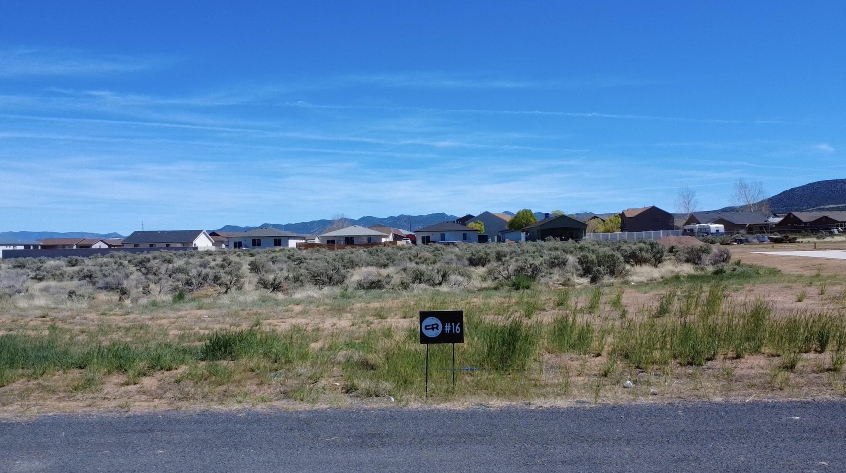 Come experience country living at its finest in Cottonwood Ranches--Enterprise's newest premier equestrian subdivision. Designed with horse lovers and those seeking space in mind, this community offers large lots ranging from 0.5 to 1.5 acres. Lot #16 features 1.01 acres of flat, usable land--perfect for building your dream home, barn, and corrals. Located within Enterprise city limits, utilities include water, power, fiber optics, and natural gas, with septic required for sewer. Up to 5 large animals are permitted. Enjoy the charm of Enterprise, a self-sufficient rural community offering grocery stores, restaurants, schools, medical services, and more--all while being just 40 minutes from St. George and Cedar City. Bring your own builder and create your ideal lifestyle. Impact fees are approximately $13,000.