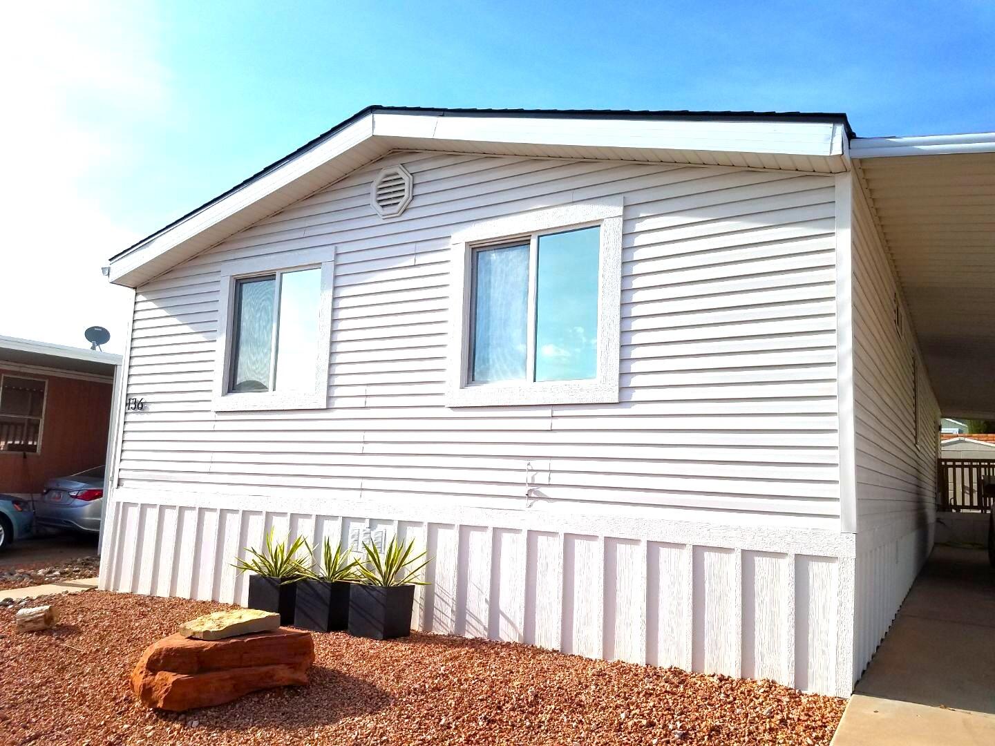 3-4 bedroom, 2 bath home in a quiet, all age community in beautiful St George. New, modern design with luxe updates typically not found in a manufactured home.  Vaulted ceilings in each room and an open, spacious floorplan.  INTERIOR:  new stainless steel appliances, quartz carrara kitchen countertop/island, grey fluted backsplash, stacked tiled floor in one bathroom and quality, light LVP flooring in remaining areas, and new, modern cabinets in kitchen and bathrooms.  EXTERIOR:  beautiful tiered landscaping ready for planting, large covered carport, storage shed, and two TimberTech composite decks with wood rails.  Both interior and exterior are newly painted with quality, neutral palette to keep or update to your liking.  This home does not include land.  You must obtain approval from Canyon View MHP through jencanyonview@gmail.com prior to offer/close.  Financing is available through https://money.com/best-mobile-home-loans/.
