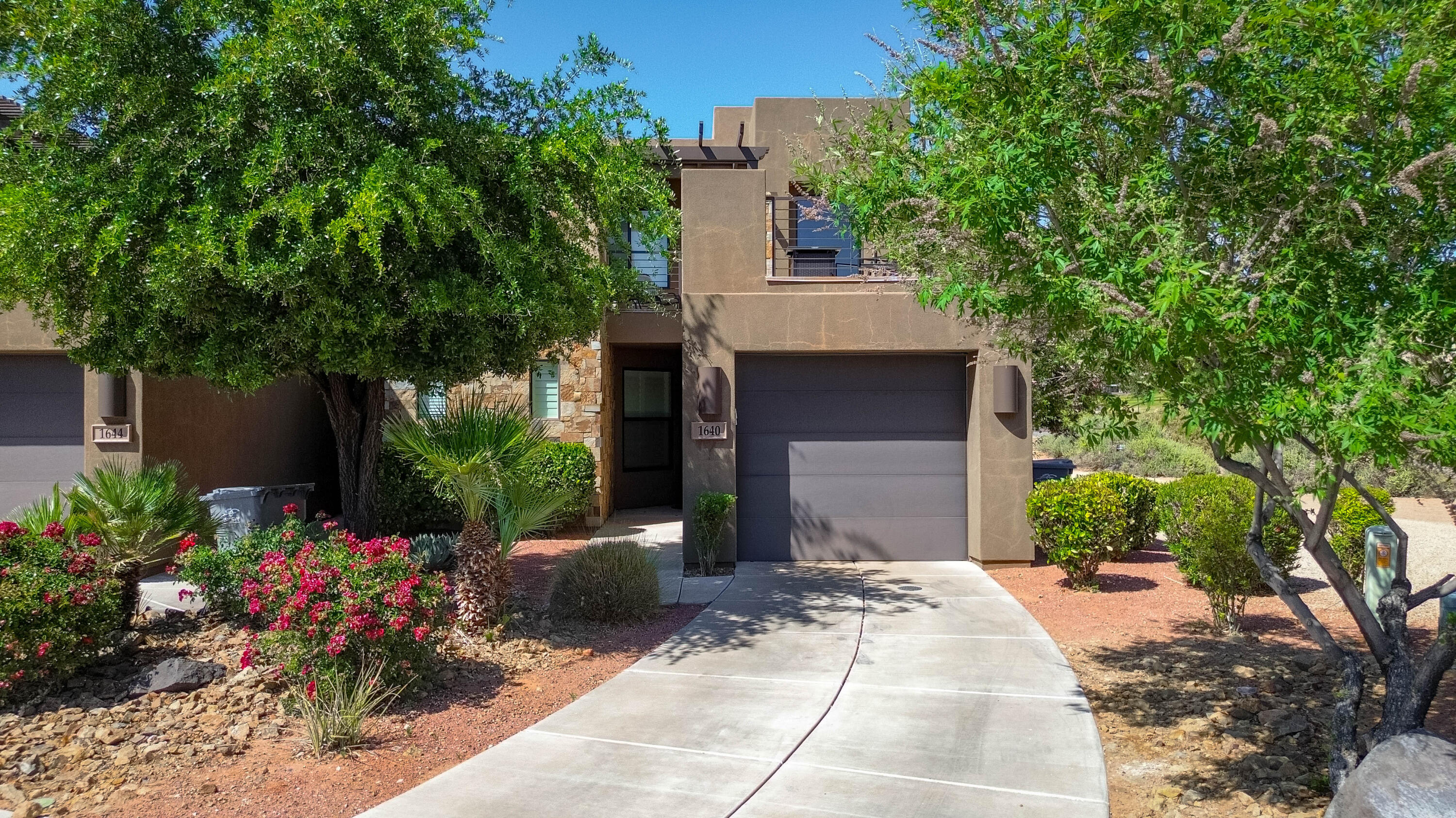 Perched along the 18th fairway of the world-class The Ledges Golf Club, this beautifully appointed two-story townhome offers the perfect blend of luxury, recreation, and investment potential. Currently operating as a successful vacation rental, the home comes fully furnished and turnkey ready. Enjoy breathtaking views of the manicured golf course and majestic Pine Valley Mountain from both the private ground-level patio and expansive rooftop patio--ideal for relaxing sunsets or entertaining guests. Located just minutes from Snow Canyon State Park, outdoor enthusiasts will love the easy access to world-class hiking, biking, and walking trails. Residents and guests alike will appreciate being directly across the street from the community pool and pickleball courts, creating a resort-style atmosphere year-round. Whether you're searching for a personal getaway, income-producing property, or both, this exceptional townhome delivers the ultimate Southern Utah lifestyle.