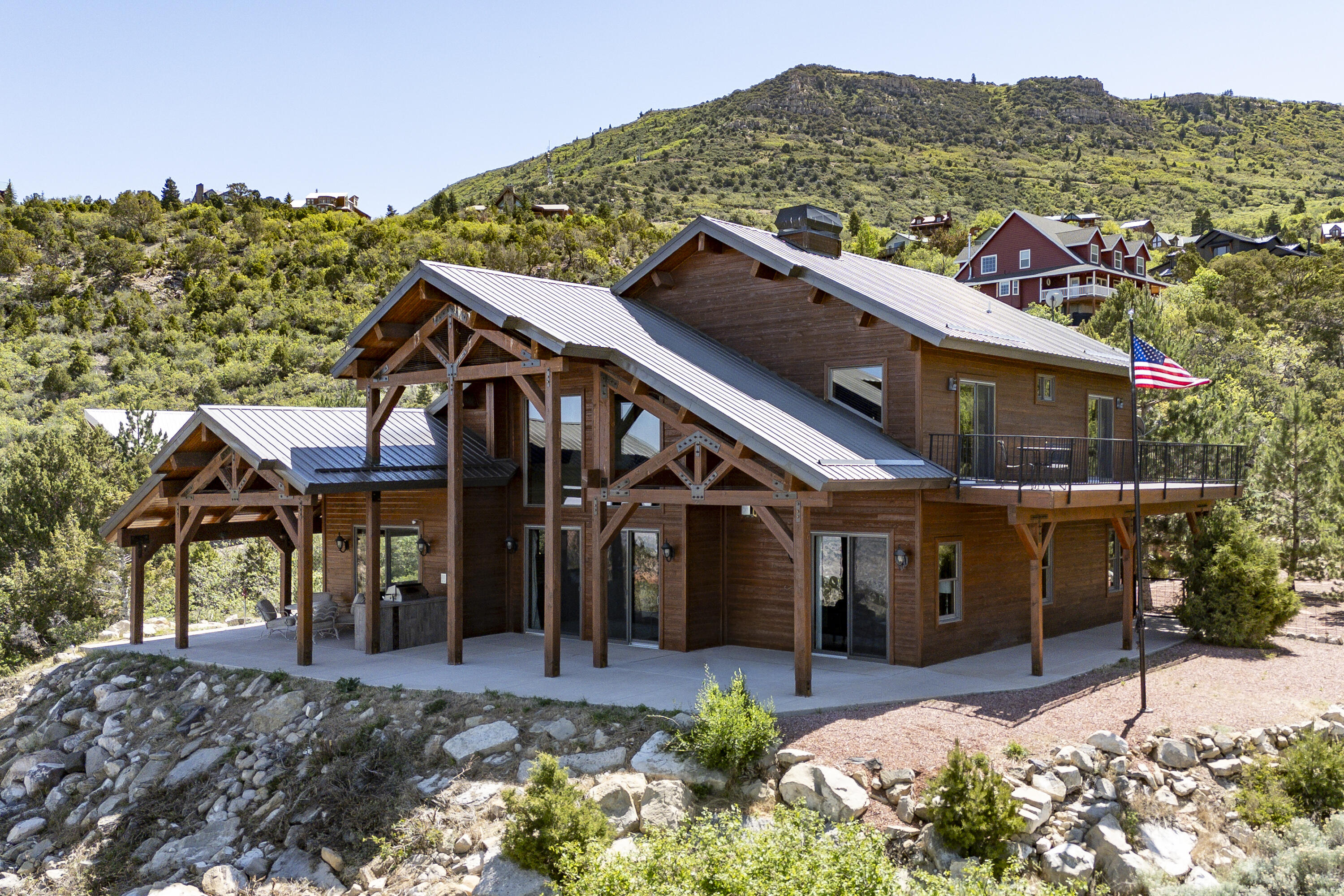 Experience mountain luxury at its finest in this extraordinary custom home, beautifully crafted with exceptional quality & timeless design. Originally built by a custom home builder for his personal residence, no detail was overlooked in the design, craftsmanship, or construction of this remarkable property. Adding to its unique value, the home includes complete floor plans as well as step-by-step construction photos from the original build, offering rare insight into the quality and care behind every detail.
The chef's kitchen is a true showpiece, featuring professional-grade Viking appliances, stunning custom cherry wood cabinetry, and upgraded granite countertops throughout. Rich architectural details abound, including exposed wood beams in the great room and upper-level bedrooms, soaring ceilings, and three floor-to-ceiling custom stone fireplaces that create warmth and grandeur. Designed with both elegance and comfort in mind, this remarkable home offers two luxurious primary suites, incredible hickory hardwood flooring, travertine, and imported Italian porcelain. Thoughtful upgrades such as an intercom system and an oversized extra-deep heated 3-car garage add convenience and functionality, along with ample RV parking.  Step outside to the spectacular outdoor living space featuring a built-in barbecue kitchen, perfect for entertaining while taking in breathtaking panoramic views overlooking Cedar City. Nestled among the trees on just under 2 acres, this private retreat offers stunning 360-degree views, year-round access, and the rare opportunity to enjoy peaceful mountain living just minutes from downtown. A truly one-of-a-kind property that must be experienced to be fully appreciated. HOA is $924 per year to cover main road maintenance and garbage.