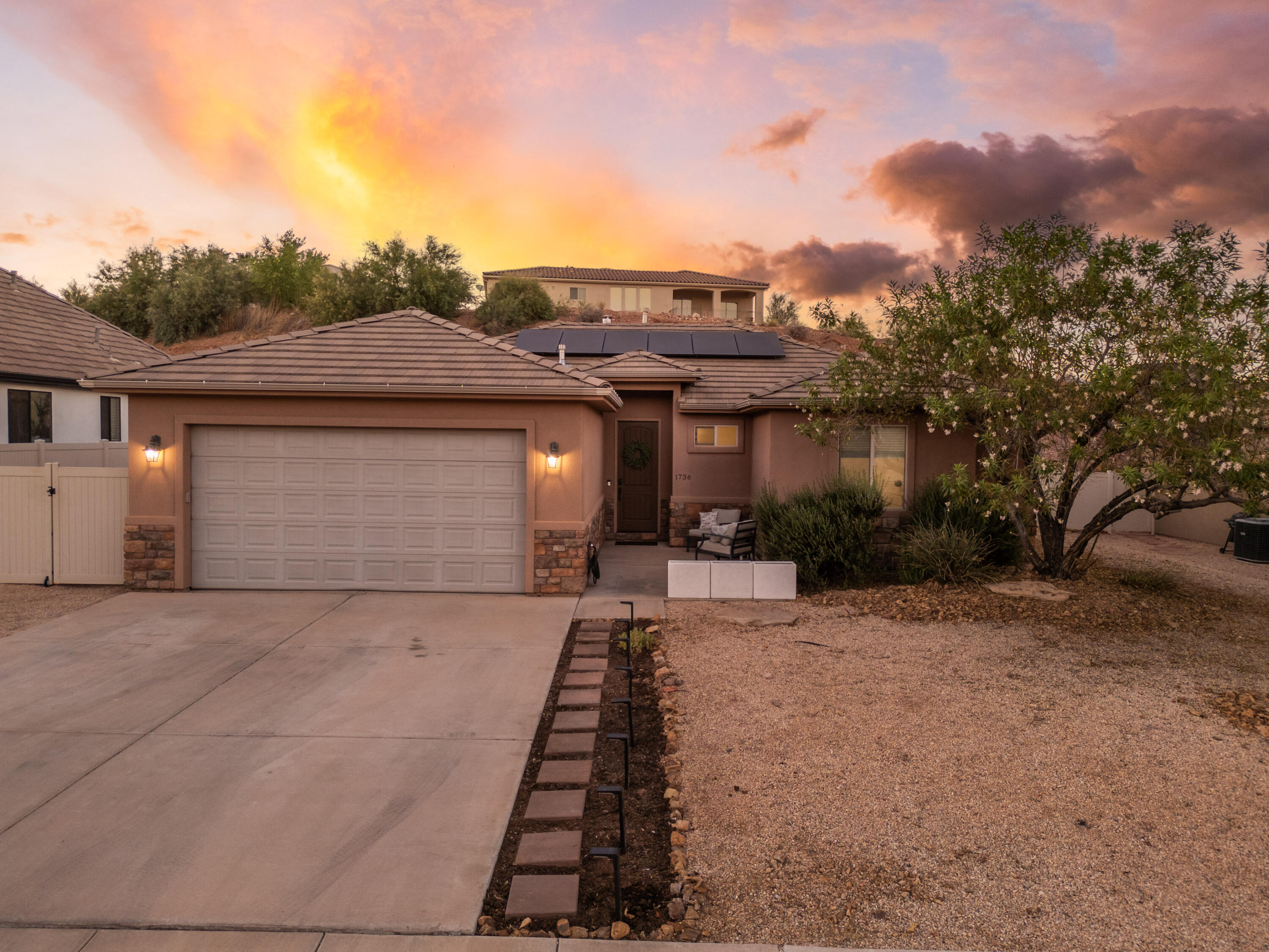Welcome to this bright and inviting home in the desirable Green Valley area of St. George. Enjoy beautiful mountain views, stunning Southern Utah sunsets, and an open-concept floor plan designed for comfortable everyday living. Offering 3 bedrooms, 2 bathrooms, granite countertops, stainless steel appliances, LVP flooring and abundant natural light, this home is both functional and welcoming. The fully fenced backyard provides privacy, a cozy fire pit, and space to relax or entertain. Solar panels add energy efficiency and help keep utility costs down. Conveniently located near shopping, dining, parks, golf, and outdoor recreation, this well-maintained home offers comfort, value, and a fantastic location. Come see all it has to offer!