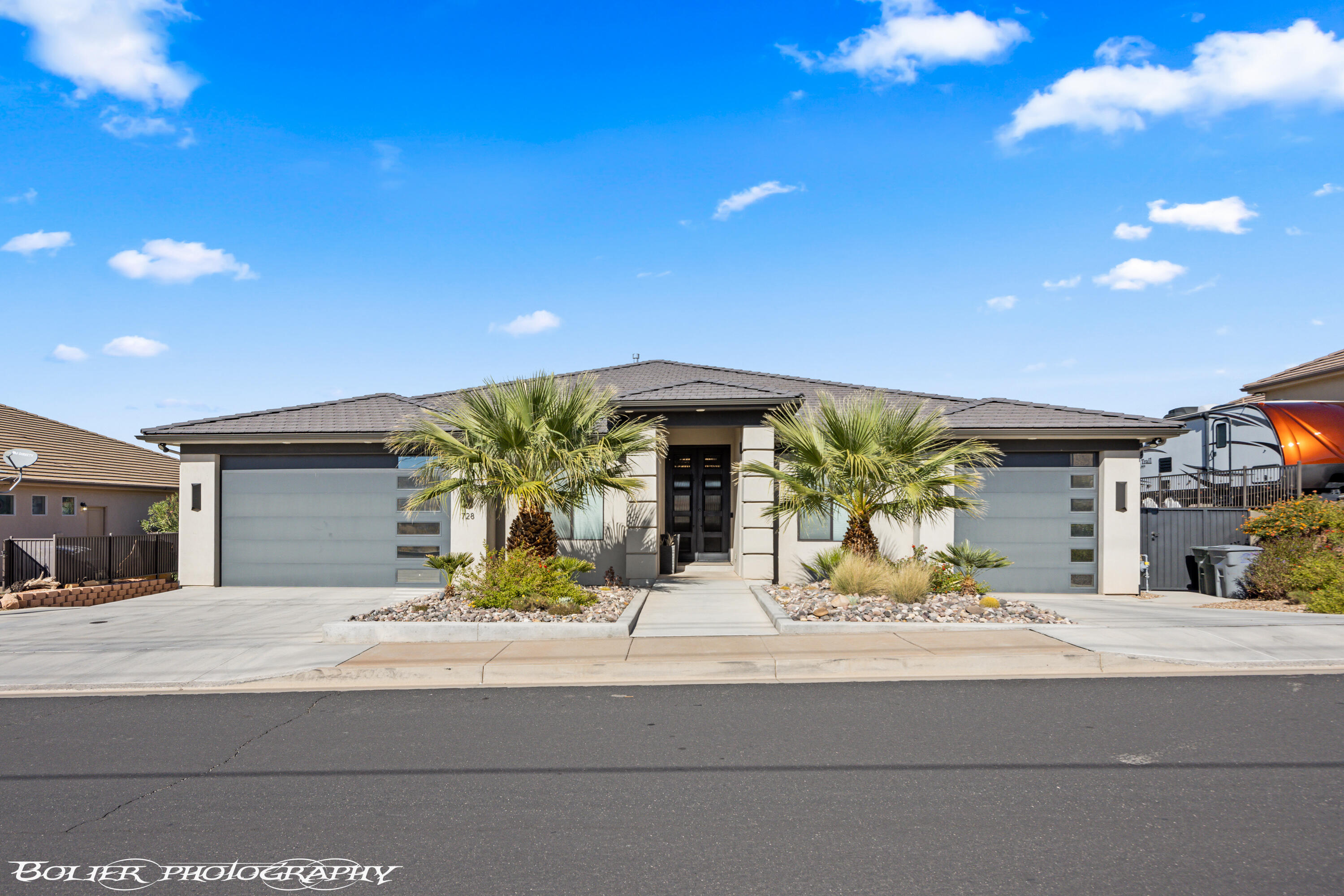 The perfect forever home, second home or investment property! 3 FULL kitchens with custom cabinetry and 3 laundry rooms. Includes a mother-in-law apartment on the main level with a private entrance, and handicap accessible. The Best Views in all of St. George. From the moment you step inside, the perfect combination of elegance and warmth will take your breath away. The open floor plan mixed with the unobstructed views will satisfy. Features 8 bedrooms, 7 full and 2 half bathrooms, The basement apartment includes 3 bedrooms and 2 bathrooms, super private. Stunning heated infinity pool and spa with misters and a fire pit, perfect for entertaining. All furniture and appliances are included!! (Artwork and statues are excluded). The main kitchen is complete with stainless steel appliances featuring double ovens, gas cooktop, an oversized island and a hidden pantry. Beautiful backlighting throughout the home. Large master bedroom, wake up to views of the mountains and city. Motion lights in master bathroom, custom closets. 12 ft ceilings on the main and 10 ft ceilings in bedrooms and basement. 2x6 construction all insulated, 4 separate systems for the HVAC! LVP flooring with weatherproof corkboard. Hidden vault in basement. Every interior wall very well insulated and sound proof. Pool equipment includes 4,000-gallon overflow, full automation with app. 7 car garages are extra width and depth, tons of shelving for storage. Plenty of parking for the family and guests. Enjoy the peaceful evenings and gorgeous sunsets. Views all of Snow Canyon, South Gate Golf Course, Tuacahn and Pine Valley Mountains! Fruit trees and garden boxes are perfect for your hobby if desired.