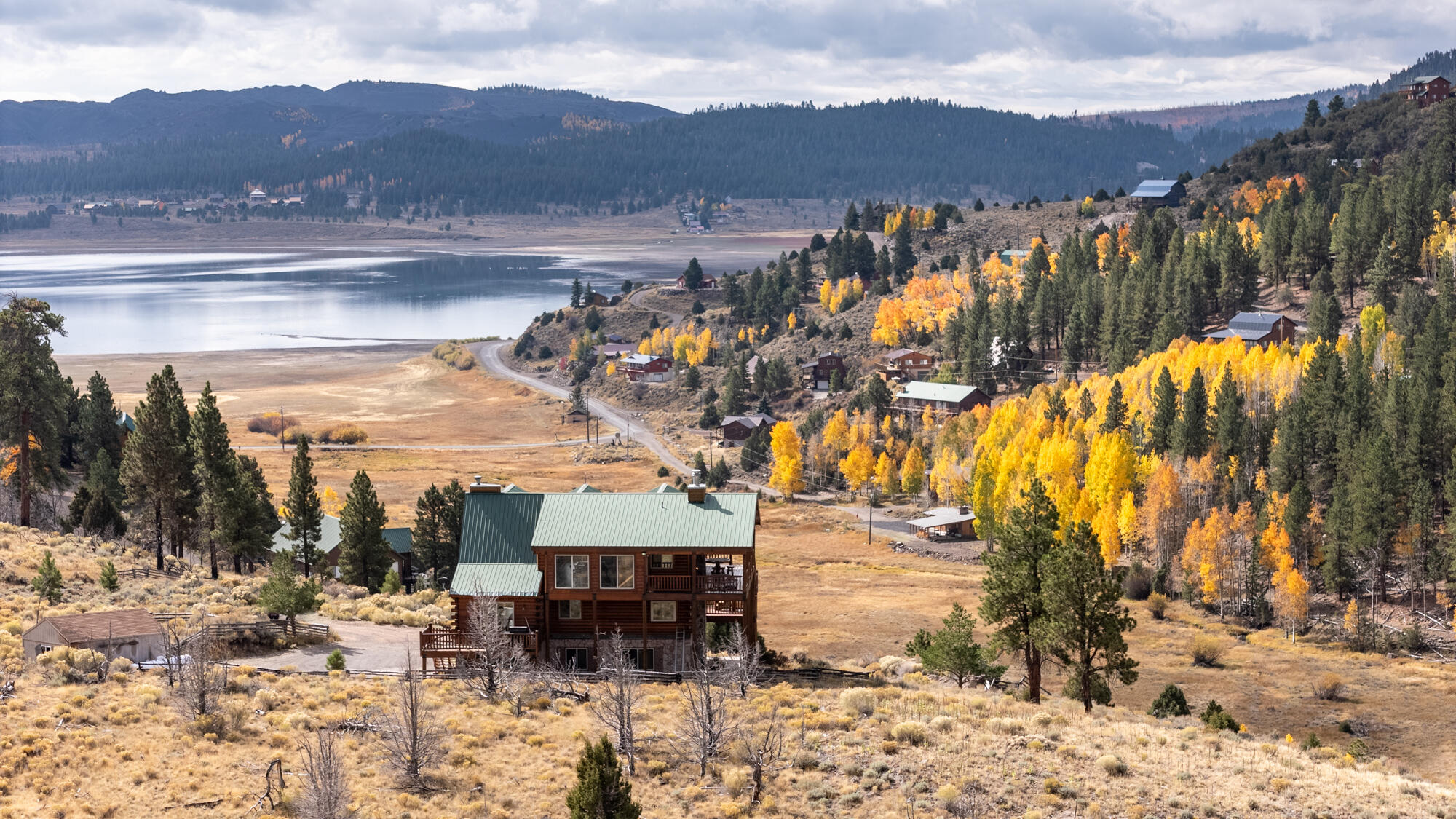Escape to the mountains and experience true Utah serenity with this stunning cabin for sale overlooking Panguitch Lake. Perfectly situated on .77 of an acres, this Southern Utah mountain retreat offers 4 bedrooms, 3.5 baths, and a spacious, open layout designed for comfort, entertaining, and breathtaking lake and mountain views. The main level features two bedrooms, a full bath, a cozy stone fireplace, and a theater room that can double as a sleep space for kids or guests. A laundry/kitchenette area adds convenience and functionality. Upstairs, the open-concept great room showcases vaulted ceilings, massive windows, and a grand stone wood-burning fireplace -- creating the perfect gathering space after a day on the lake. The gourmet kitchen includes double wall ovens, ample counter seating, and a large dining area, ideal for hosting family and friends. The primary suite captures panoramic views of Panguitch Lake and features a two-sided gas fireplace shared with the luxurious ensuite boasting a jetted tub and walk-in shower. A half bath completes this level. The loft level offers a private bedroom with a stone fireplace and a full bath with a beautiful stone shower. This space also doubles as a game room complete with shuffleboard, dart board, pool/ping pong table, card table, and a wet bar-perfect for entertaining year-round. Step outside to enjoy expansive decks with both covered and open areas ideal for relaxing, barbecuing, or entertaining. Gather around the outdoor fire pit area under the stars and roast marshmallows. A storage shed provides extra space for lake gear, ATVs, or mountain equipment. With its warm tongue-and-groove wood finishes, this Panguitch Lake cabin delivers the ideal balance of rustic charm and modern luxury   just minutes from world-class fishing, boating, and outdoor recreation. Adjoining lot for sale and can be purchased in package deal, 452 N Scenic Drive, MLS 26-270858.