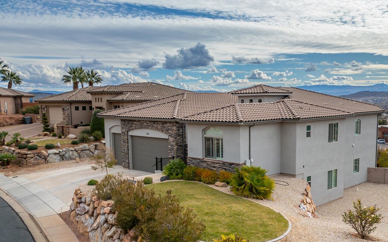 Experience elevated living with mountain, city, & red rock views in lovely Castle Rock. Designed for seamless multi-generational living, you'll find a private studio Casita with a kitchenette, bathroom, walk-in closet, & interior & exterior entries. The main floor AND walkout basement levels have upgraded full kitchens with wall ovens, cooktops, large walk-in pantries, family rooms, storage closets, & laundry rooms. This custom home, built by Bret Henderson Construction, features large bedrooms, 10' ceilings, 8' doors, a grand foyer, tray ceilings, a transom window, & beautiful white shutters. The chef's kitchen offers ceiling-height cabinetry, a hidden pantry, a wall oven, a gas cooktop, red rock view, & an expansive island. Spacious primary suite with chandelier, jetted tub, 2 shower heads, double vanity, oversized closet, & deck access. Walkout basement with full kitchen, theater, 2nd family room, 2nd laundry, & storage. In addition, there is no HOA, the seller is the original owner, there is room for a pool, & the utilities are LOW! Just under $350 on average over the last year! The lot is .74 acre, but the back portion of the lot, next to Snow Canyon Parkway, is a No Disturb / No Build Zone; see the plat map in the photo section.  Near Tuacahn, Snow Canyon, Harmons, Digbys, Black Desert, trails, shopping, movies, and more.