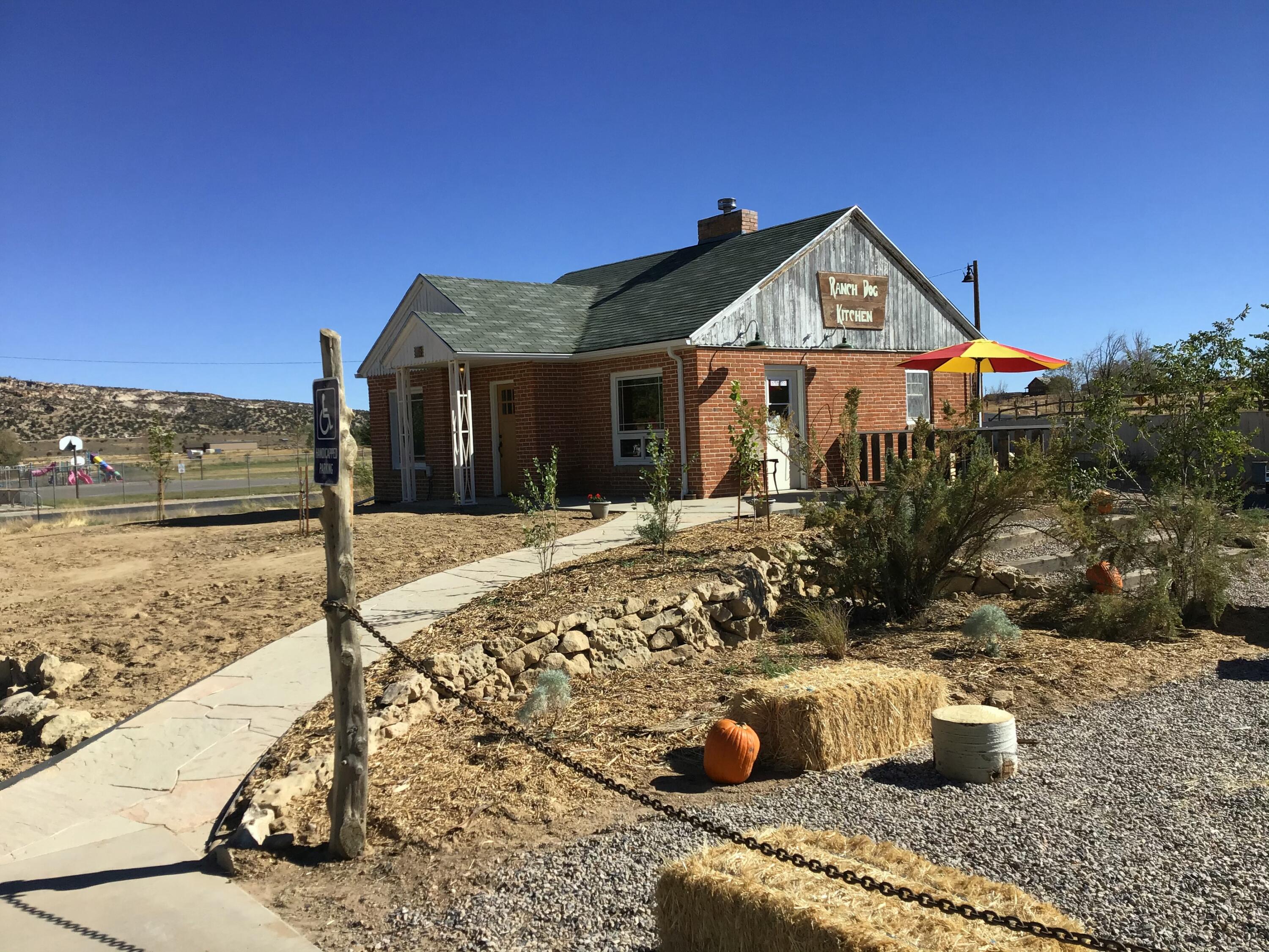 Formerly the Ranch Dog Kitchen, this 1930's era commercial space has all the charm of years gone by, while tastefully modernized for the 21st century.
Ideally located along the iconic Highway 12 Scenic Byway, in the heart of Escalante and the Escalante Grand Staircase Monument, this Main Street property is the ideal spot for someone looking to bring their small business to this charming little town.
The options are endless with this space-  restaurant, art gallery, short term rental, etc.
Space includes a two bedroom basement with kitchenette for owner or employee housing.
Upstairs is the high end commercial kitchen, serving/dining area, and bathroom, with room to expand if needed. Outside is cozy dining or gathering area with covered seating that has also doubled as a stage for town music festivals. An added bonus is being directly across the street from an Escalante City park and the new pickleball courts they are building!