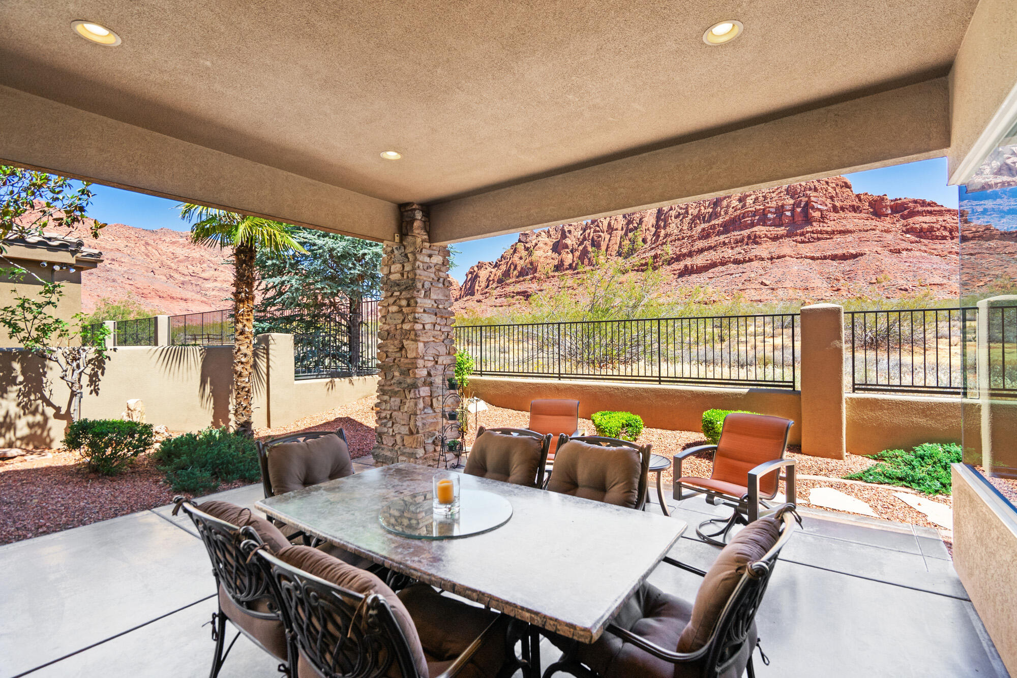 **Offered fully furnished for a seamless move-in experience!** New listing in the beautiful gated community of Vermillion Cliffs, nestled beside the state park with unobstructed views of the stunning Red Cliffs. This exceptional home offers everything you've been searching for, featuring 3 bedrooms, 3.5 bathrooms, and a grand foyer with soaring ceilings that warmly welcome you into this elegant residence.

Designed with both comfort and style in mind, the home showcases an open-concept floor plan with a spacious great room highlighted by custom stonework and a cozy gas fireplace. Home is wired and equipped with speakers inside and out. Large picture windows perfectly frame the breathtaking Red Rock Cliff views, creating an inviting atmosphere throughout the home.

The custom kitchen is beautifully appointed with stainless steel appliances, 6 burner gas range, granite countertops, a large breakfast bar, porcelain tile, custom LED light fixtures, and recessed lighting throughout. Energy efficiency was also a priority, with tinted windows, added attic insulation and a radiant barrier installed beneath the entire attic to help minimize utility costs. Also, garage floor is sealed for easy clean up. 

Step outside to your own private backyard oasis featuring an acid-stained patio, built in gas BBQ and outdoor hot tub--perfect for relaxing while taking in the incredible red rock scenery. Backing directly to the state park, the property offers exceptional privacy and tranquility.

This is truly a must-see home that will not disappoint. Once you experience everything it has to offer, you'll want to call it your own. Schedule your private showing today.
