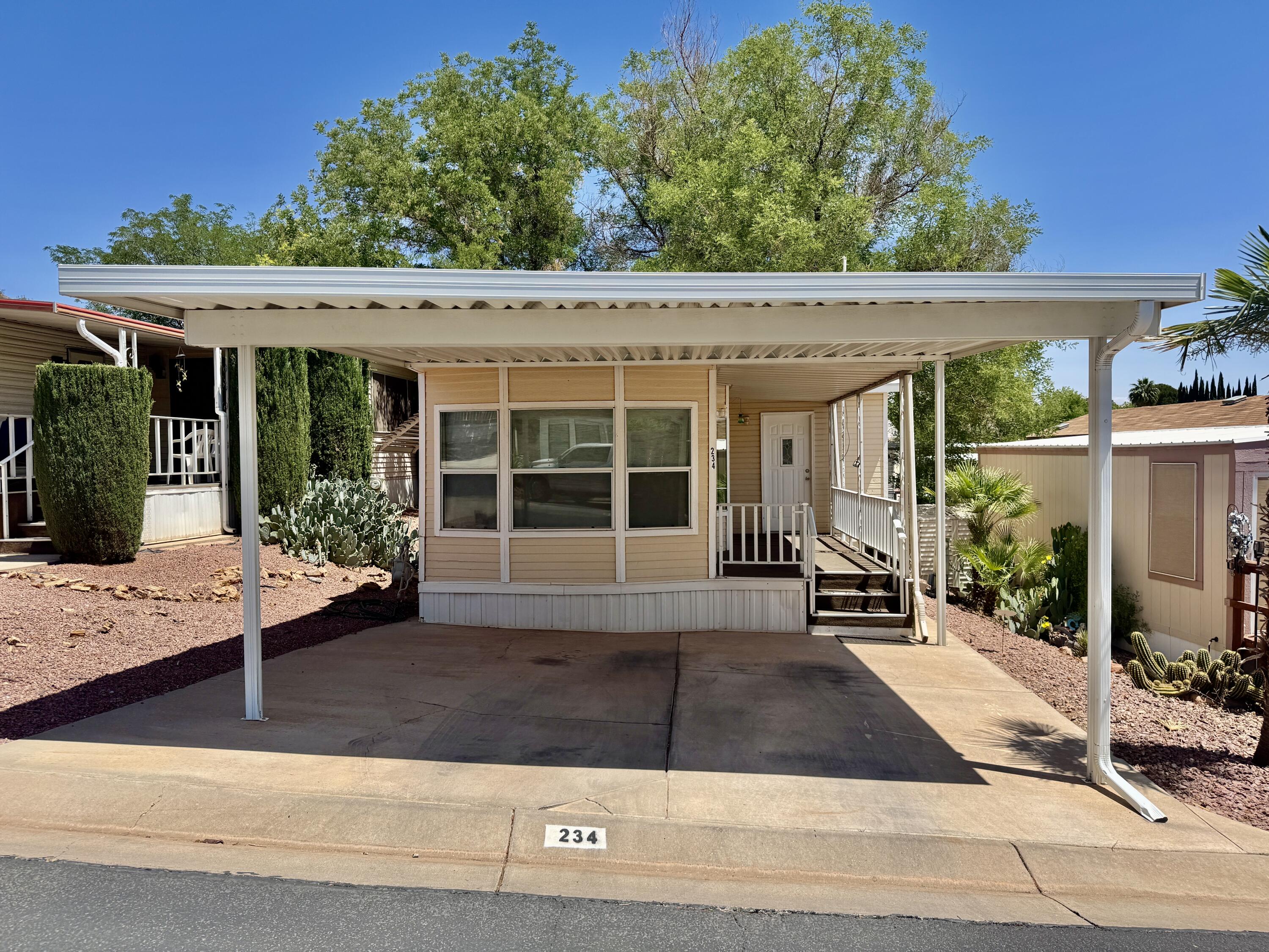 55+ Community in a smaller RV park! This 2 bedroom, 2 bath home features nice flooring, a spacious porch, and comfortable living space. Enjoy community amenities including a pool, clubhouse, and gym, all with a low HOA. Buyer to verify all information.