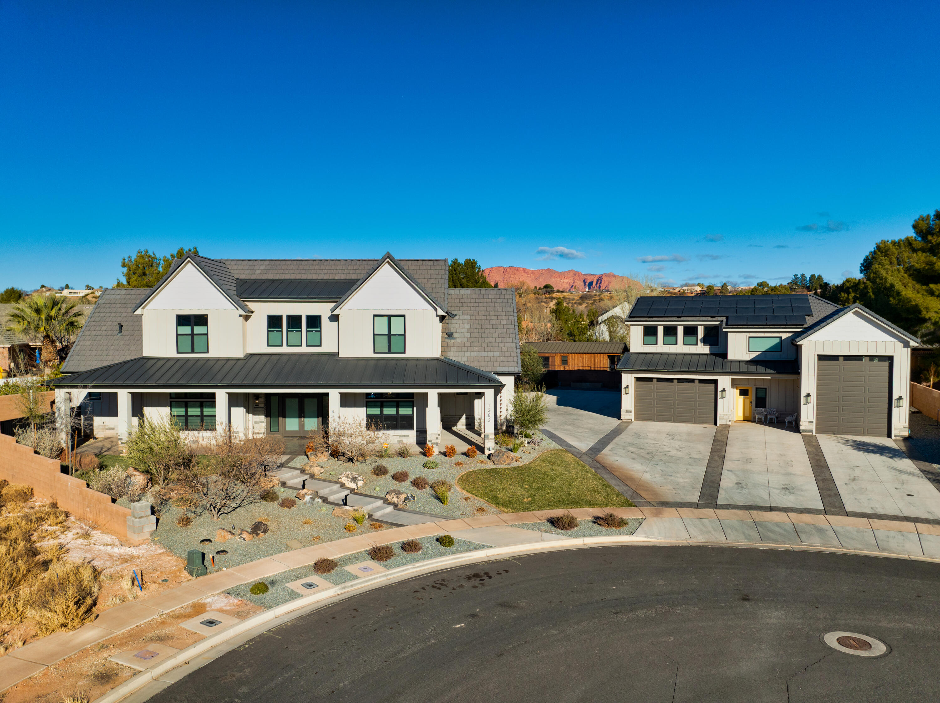 This unique home blends modern luxury & thoughtful functionality on a spacious .51-acre lot. This meticulously designed home is perfect for those seeking comfort, convenience & outdoor entertainment. The main floor offers primary suite with en-suite bathroom & walk-in closet for your private retreat, spacious office with private entrance ideal for remote working, large gourmet kitchen w/butler's pantry, mudroom, family room & half bathroom. Upstairs offers 3 bedrooms including 1 bedroom w/ en-suite bathroom, full bathroom & a 2nd family room area. Basement offers a fantastic space for all your storage needs. Note: Separate building adjacent to main home features a furnished 1 bed 1 bath apartment fully furnished. RV bay w/hookups, 2nd bay extra deep w/workbench, storage & 1/2 bath.