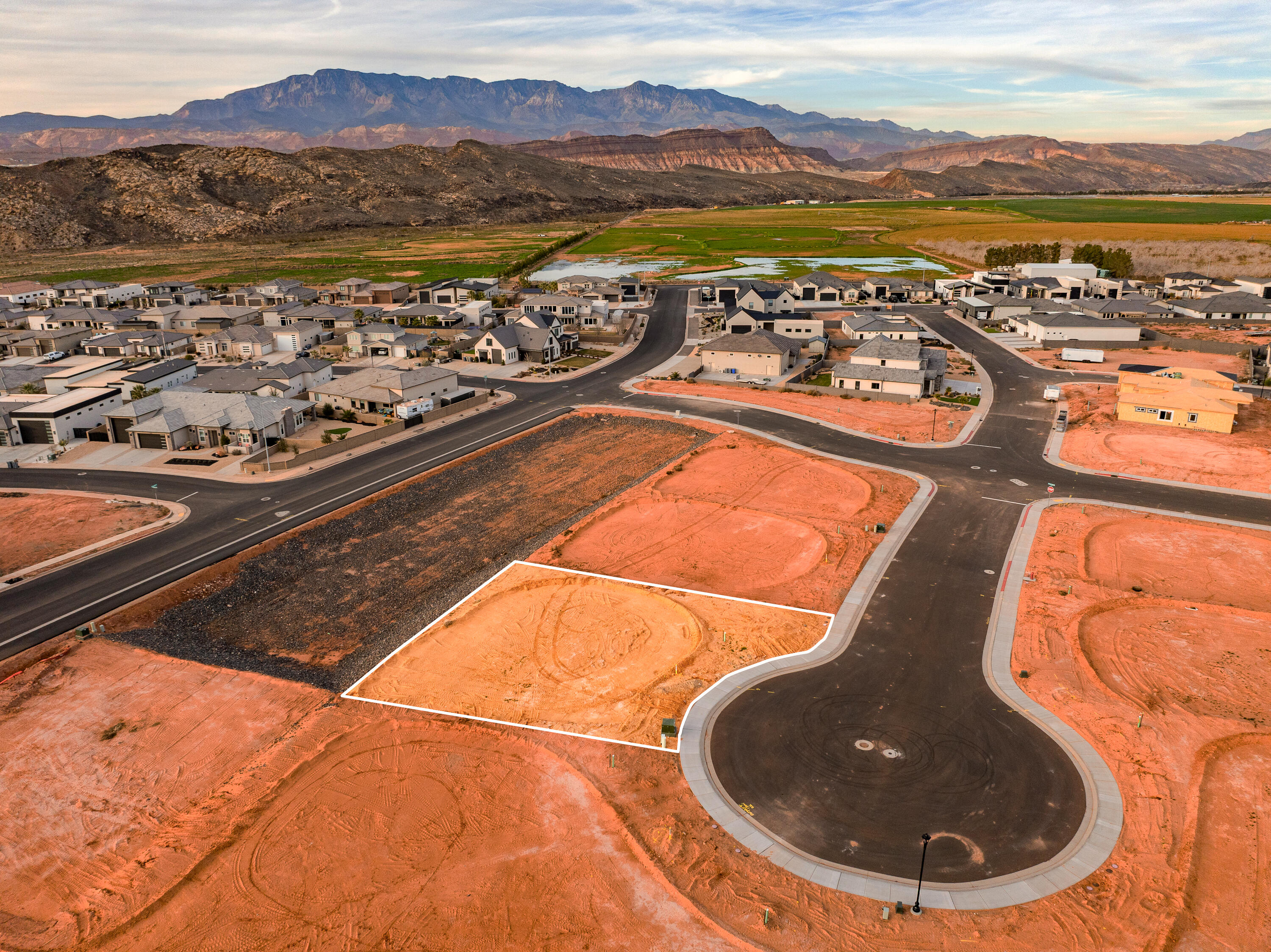 A short RZR ride from Sand Hollow Reservoir and the sand dunes, adventure starts at your garage door. Lot 47 is elevated above a storm water basin and offers a stunning unobstructed view! Build your home base for adventure in Phase 2 of Sand Hollow Village. This lot was made for people with toys—ideal for a modest home with a massive RV garage. Keep your camper, boat, side-by-side, Jeep, and motorcycles...all the gear...on site and skip the storage unit. A place to launch big weekends, unwind after long days outside, and settle in for the long haul—whether you're growing a family or easing into retirement. Friendly, clean neighborhood with sensible CC&Rs that protect quiet enjoyment. No snooty HOA. All builders welcome. Call for an introduction to a home builder.