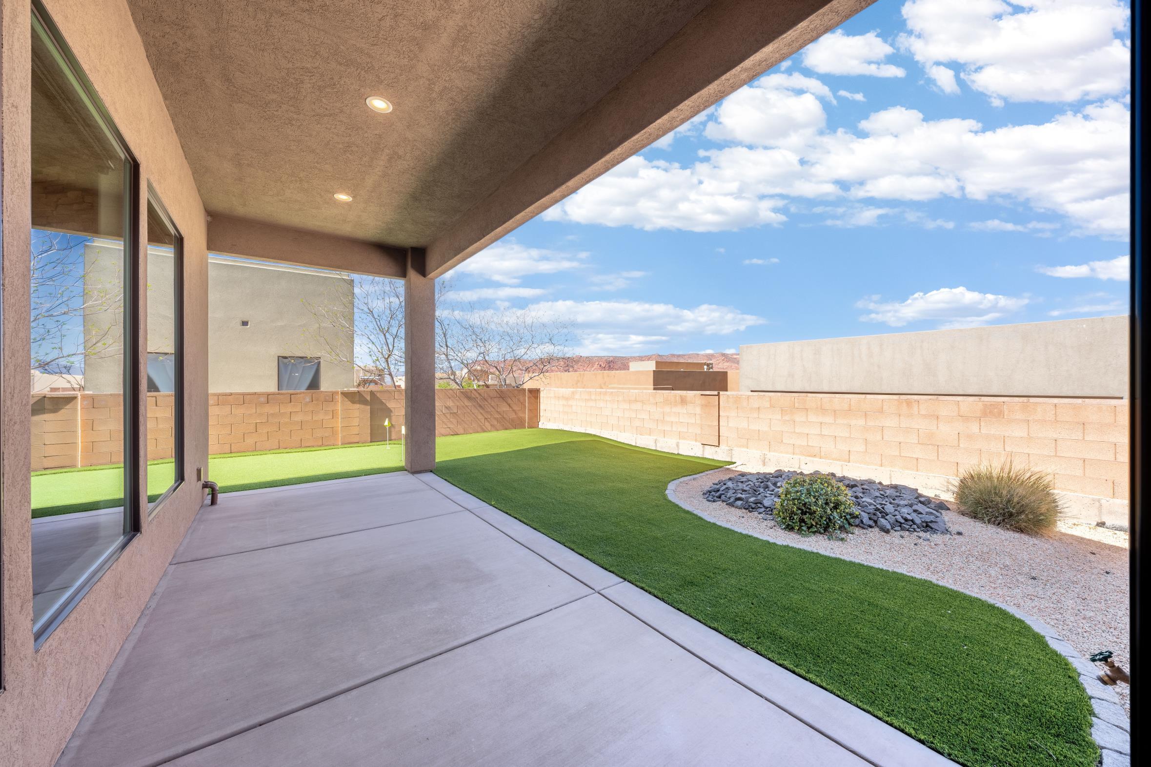This spacious three-bedroom, 2.5 bath residence features tall ceilings and an open floor plan, perfect for modern living and entertaining. Enjoy the red rock views from your kitchen and backyard while practicing your putting with the putting green. This home boast numerous upgrades, including a cozy gas fireplace, automatic blinds, and big walk in closets. For your convenience, the property also includes Three-car garage, providing plenty of space for vehicles and additional storage.