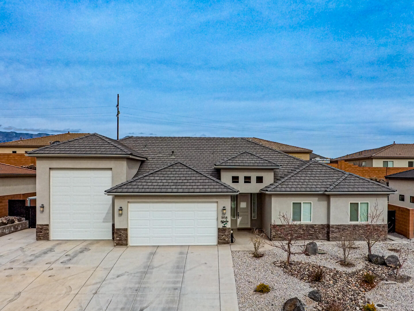 This one checks so many boxes! Open spacious gathering areas in the main part of the interior, including an open kitchen with modern appointments. Ample primary bed and bathroom area, wall mounted TV included, 3 other bedrooms for guests or dependents, desert landscaping for ease of use with some grow boxes and garden spot including productive blackberry bushes. Cement skirting around entire parameter of the yard, Add the Massive 1229 feet of garage space with ample door height and 53' foot length for a large class A RV, including an exterior covered parking or work area, and so much more.  Come and check it out before it slips away.