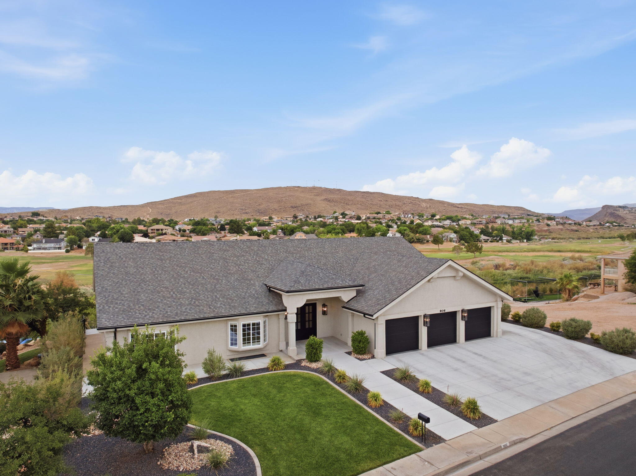Thoughtfully reimagined from top to bottom, this stunning home blends modern luxury, and panoramic golf course views. Inside, you'll find 5 bedrooms, 3.5 bathrooms, soaring ceilings, expansive windows, designer finishes, a modern fireplace, and a chef's kitchen featuring an oversized island, custom cabinetry, quartz countertops, and premium appliances. The primary suite offers a spa-inspired bathroom with dual vanities, a freestanding soaking tub, oversized walk-in shower, and an impressive custom closet. Step to your backyard from the walk-out basement to expansive covered patios overlooking the beautifully landscaped backyard. Complete with a 3-car garage, RV parking and no HOA, this move-in ready home delivers exceptional craftsmanship, incredible views, and an unbeatable location close to golf, parks, shopping, dining, and more.