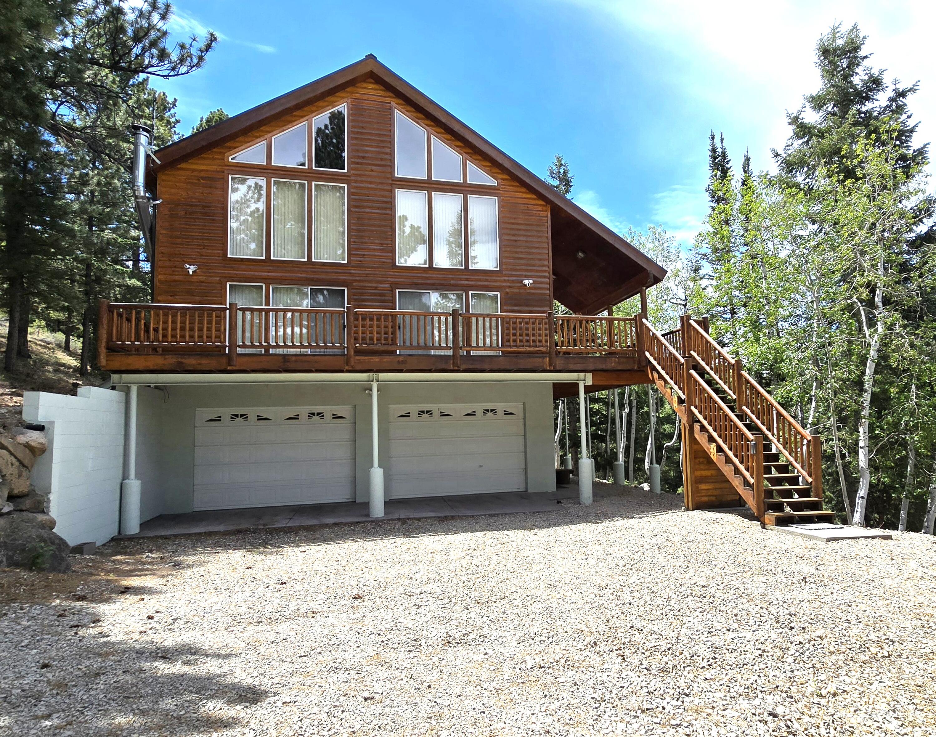 Welcome to your dream mountain escape at Panguitch Lake! Boasting  lake &  mountain views, this thoughtfully designed multi-level cabin features a spacious open floor plan perfect for hosting large gatherings of family and friends. The main level serves as the heart of the home, showcasing a lg living room with a wood burning stove set into a stunning rock fireplace. There's a lg dining area and a fully equipped kitchen with a propane range, maple cabinets,  pantry, d/w, t/c, and counter seating for extra guests. Sliding glass doors and windows in the L/R and D/R areas flood the space with natural light. Relax on the expansive deck and cov side porch or tinker in the man cave garage. The main level also features the comfortable Owner's Suite, highlighting a walk-in closet with built-in drawers and bath w/linen closet, tub/shower combo & heat lamp. There's a guest half bath, laundry room w/sink & outside entrance. Upstairs, you'll find a spacious loft/den for extra sleeping space or rec area, a second full bath, and two bedrooms featuring vaulted ceilings, window seating and bonus overhead storage.
A standout feature is the massive 1,280 sq ft multi-use garage. It provides unparalleled secure storage for boats, trucks, UTVs, and snowmobiles, with a footprint perfectly suited to be partially finished into a bunkhouse or rec room. The cabin is equipped with a fire sprinkler system in all rooms, a home monitoring system and a propane furnace w/massive 1,000-gallon tank.
Unbeatable access to world-class recreation: - Panguitch Lake Fishing: Minutes away (Blue Ribbon trout) - Cedar Breaks National Monument: ~15 miles (~20 mins) - Brian Head Ski Resort: ~18 miles (~25 mins) - Bryce Canyon National Park: ~30 miles (~40 mins) - Zion National Park (East Entrance): ~60 miles (~1.5 hours) - Access to Dixie National Forest hiking, biking, and premier OHV/ATV trails. 

Act fast--lake-view cabins with this level of garage capability are a rare find!