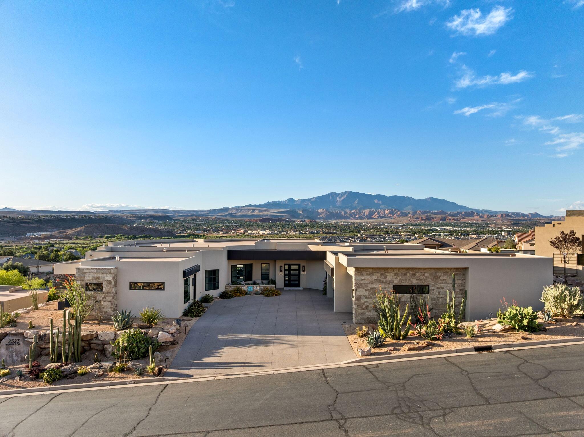 Set within the gates of Stone Cliff, this beautiful residence offers something increasingly rare: nearly 4,400 square feet of refined, single-level living with no detail left to chance.

From the moment you arrive, floor-to-ceiling glass frames uninterrupted north-facing views of Southern Utah's Pine Valley mountains and sky. The living spaces flow with an ease that makes both grand entertaining and quiet mornings feel equally at home. At the heart of it all, a kitchen built to impress: Thermador appliances, custom cabinetry, and an exceptionally generous butler's pantry ready for a dinner party or a coffee for two.

Three private bedroom suites each enjoy their own en-suite bath and direct exterior access, offering guests and family true retreat. The primary suite is a sanctuary unto itself: expansive windows, a spacious layout, and dual private baths and closets designed around comfort.

Outdoor living is just as considered, an oversized spa that doubles as a low-maintenance pool, a built-in barbecue, and a spot to practice you pickle ball. Car enthusiasts and hobbyists will appreciate the RV garage, two additional stalls with EV charging, an enclosed workshop, and abundant storage, room for every toy and pursuit.

Beyond your door, Stone Cliff delivers a resort lifestyle: tennis and pickleball, bocce, a full fitness center, indoor lap pool, a resort-style outdoor pool with cabanas, and a community center for gatherings. Whether a full-time residence or an effortless second home in the sun, this is low-maintenance luxury with nothing left to do but enjoy it.