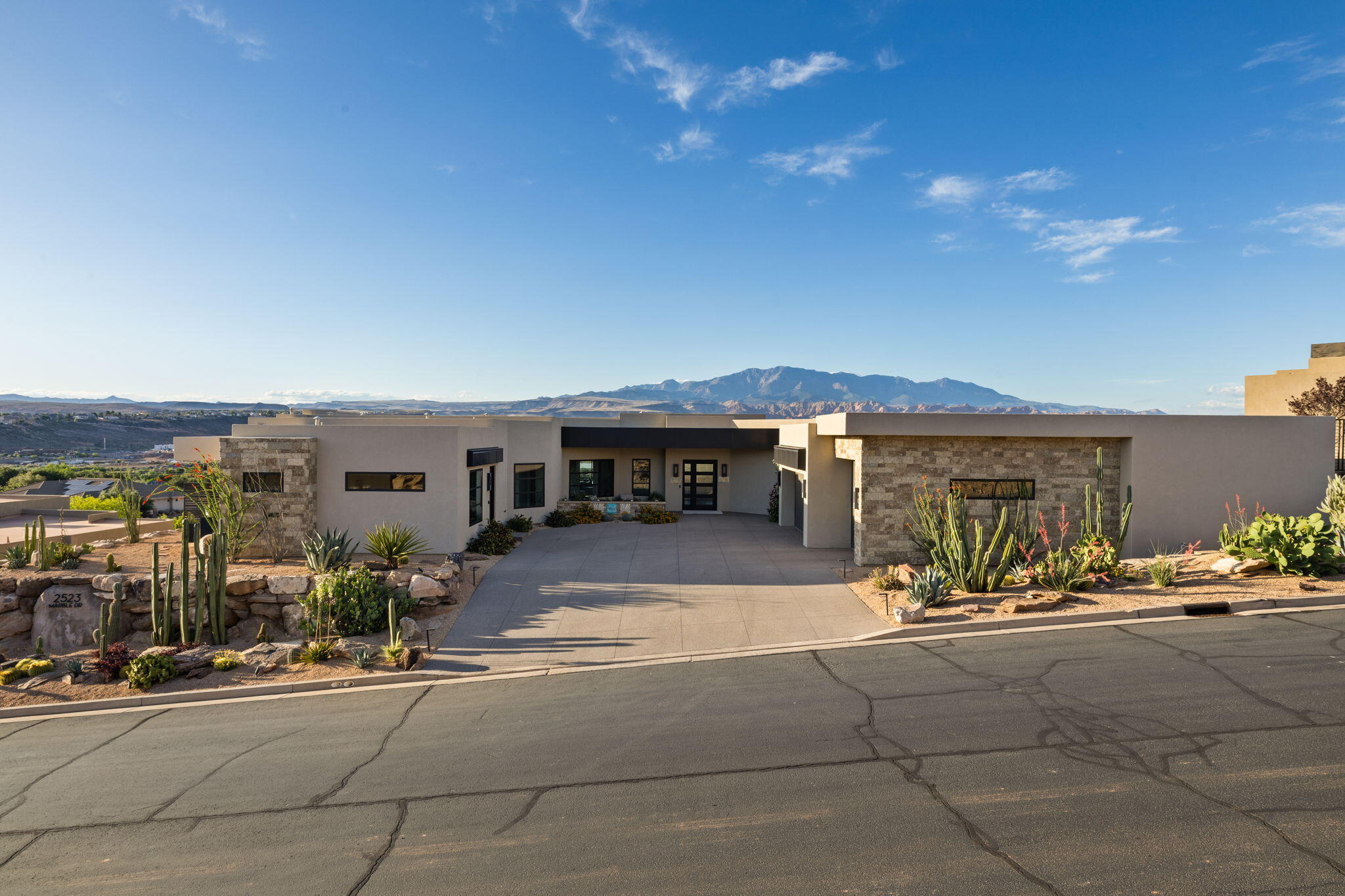 WOW -- the views on this one!

This turn-key home, built in 2020, features tasteful finishes and timeless design throughout. Located in one of St. George's most prestigious neighborhoods, Stone Cliff, it offers nearly 4,500 square feet with an ideal single-level layout.

There are three private bedroom suites, each with its own en-suite bath and exterior access. The primary suite showcases sprawling windows with expansive views, a spacious floor plan, and dual private bathroom/closet spaces designed for both comfort and retreat.

The kitchen is built to impress, featuring Thermador appliances, custom cabinetry, and an unexpectedly large butler's pantry -- perfect for meals of any size. The functionality and storage throughout this home are incredible; it truly needs to be seen in person to be fully appreciated. Floor-to-ceiling glass captures panoramic north-facing views, highlighting everything we love about Southern Utah.

Step outside to an oversized spa that can double as a low-maintenance pool, a built-in barbecue, and a petite sports court. The RV garage, plus two additional parking stalls already equipped with an EV charging station, offers room for all the toys -- and even space for a workout area. Don't miss the enclosed workshop and additional storage areas as well.

Stone Cliff is guard-gated 24/7 and offers resort-style amenities perfect for an active lifestyle: tennis courts, pickleball courts, bocce ball, a full fitness center, indoor lap pool, outdoor pool with beautiful cabanas, and a community center for hosting gatherings and events.

Whether you're looking for a primary residence or a second home to escape to in sunny St. George, this property delivers stunning views, beautiful finishes, a functional layout, and an easy, low-maintenance lifestyle.