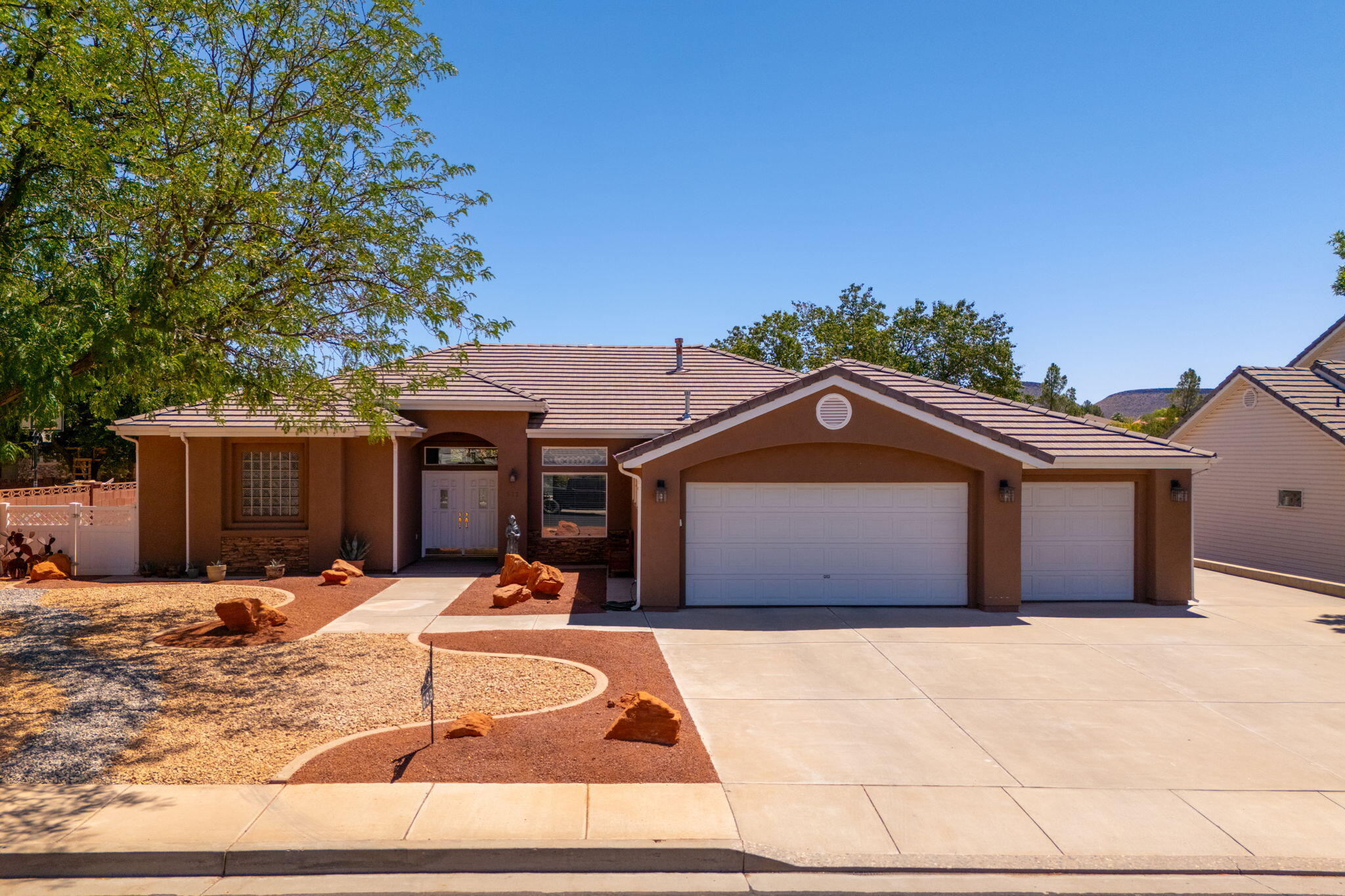 Welcome to this exceptional home in the highly desirable Country Lane Estates, one of Santa Clara's premier neighborhoods. Perfectly situated just minutes from Arrowhead Elementary, Snow Canyon High School, shopping, dining, and entertainment, this property offers the ideal combination of comfort, convenience, and space.

Set on a spacious lot with no rear neighbors and no HOA, you'll enjoy added privacy and the freedom to make this property your own. The fully fenced yard is shaded by mature trees, creating a peaceful outdoor setting with plenty of room to relax or entertain.

Inside, the open-concept floor plan is filled with natural light thanks to expansive windows, while soaring ceilings enhance the home's bright and airy feel. Generously sized bedrooms provide plenty of space for family and guests, and a dedicated office offers the perfect place to work from home or create a quiet retreat.

Practical features abound, including a three-car garage, dedicated RV parking, and abundant additional parking for visitors, trailers, or recreational vehicles.

This is a rare opportunity to own a beautiful home in one of Santa Clara's most sought-after neighborhoods. Schedule your private tour today and discover everything this exceptional property has to offer.