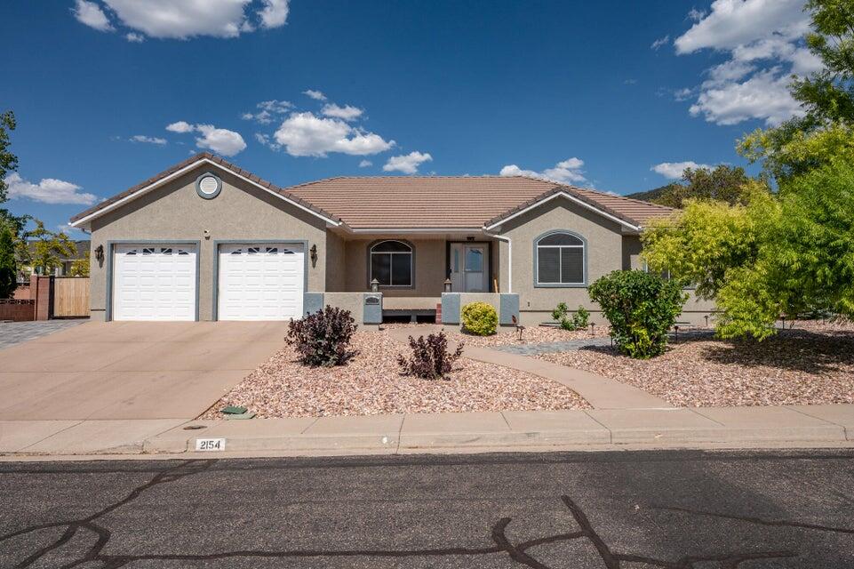 Sitting on a quarter acre, this 3,852 sqft fully furnished home offers space for just about any gathering. With six bedrooms and 3.5 baths, it provides ample space for family and guests. Upon entering, you'll find a flexible room that can serve as a den, office, or dining area. The heart of the home is the sunlit living room, complete with a cozy fireplace. The kitchen, with its dining bar and large windows, leads directly to the back patio, ideal for outdoor dining. The master bedroom offers a private retreat with a spacious bath and two walk-in closets, opening to the backyard. Two additional bedrooms and another full bathroom ensure everyone has their own space. The basement features a second kitchen, a family area, a full bath and 3 bedroom