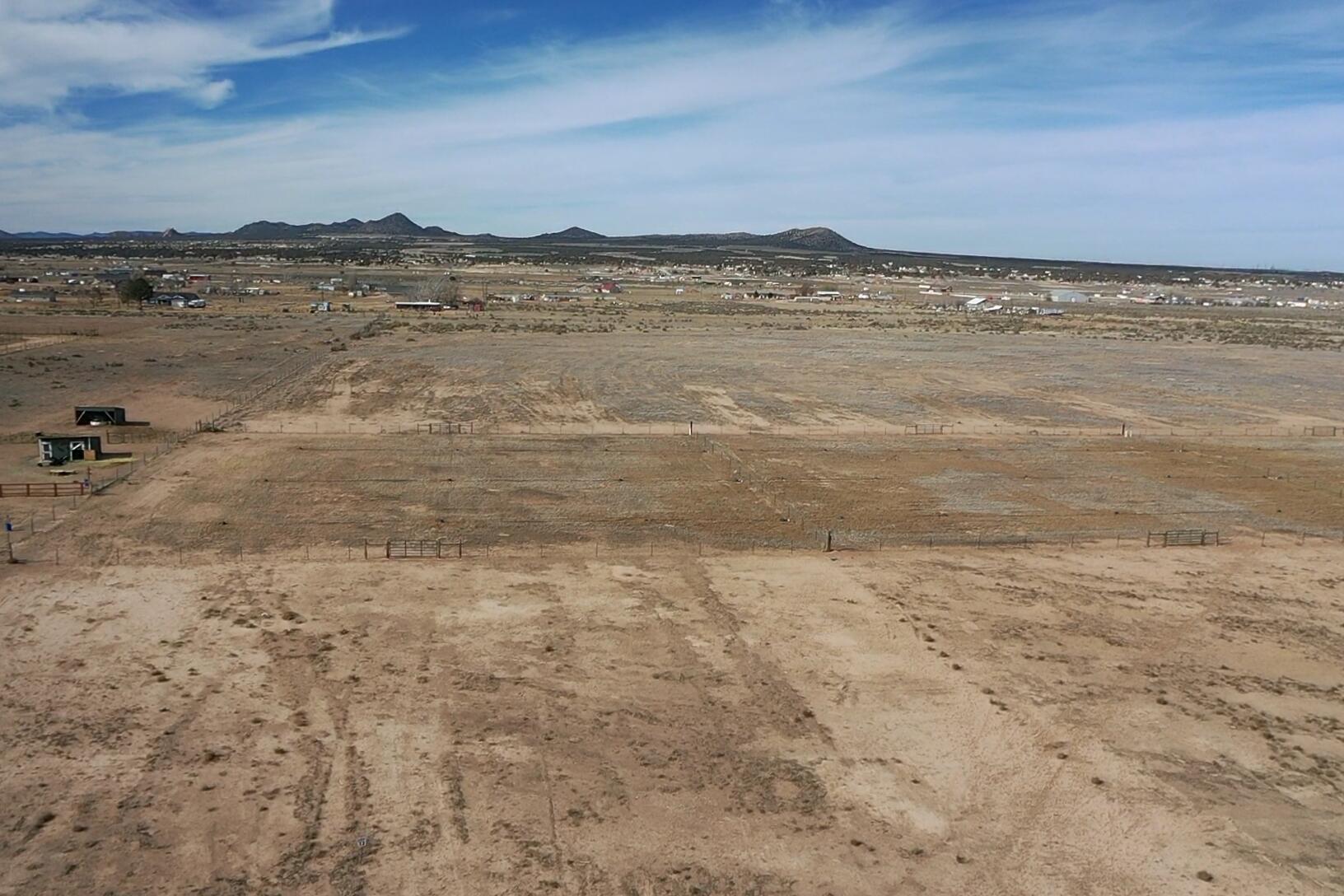 This spacious 5.33 acre lot in the Peak View Ranchettes subdivision offers an impressive amount of land, measuring 213.77 feet wide and 1004.49 feet deep. The property is easily accessible via a county-maintained paved road. You have the flexibility to bring your own builder. Utilities with Rocky Mountain power, already stubbed to the lot. Each lot comes equipped with a culinary water connection through the Water Conservancy District and includes 4 acre ft of water in the Peak View Ranchettes Irrigation Company. Notably, the sellers have installed secondary irrigation systems, making it easy to provide water for pastures and gardens. The lot extends beyond the existing fence line, offering additional space beyond the enclosed area, enhancing the overall appeal of this remarkable property.