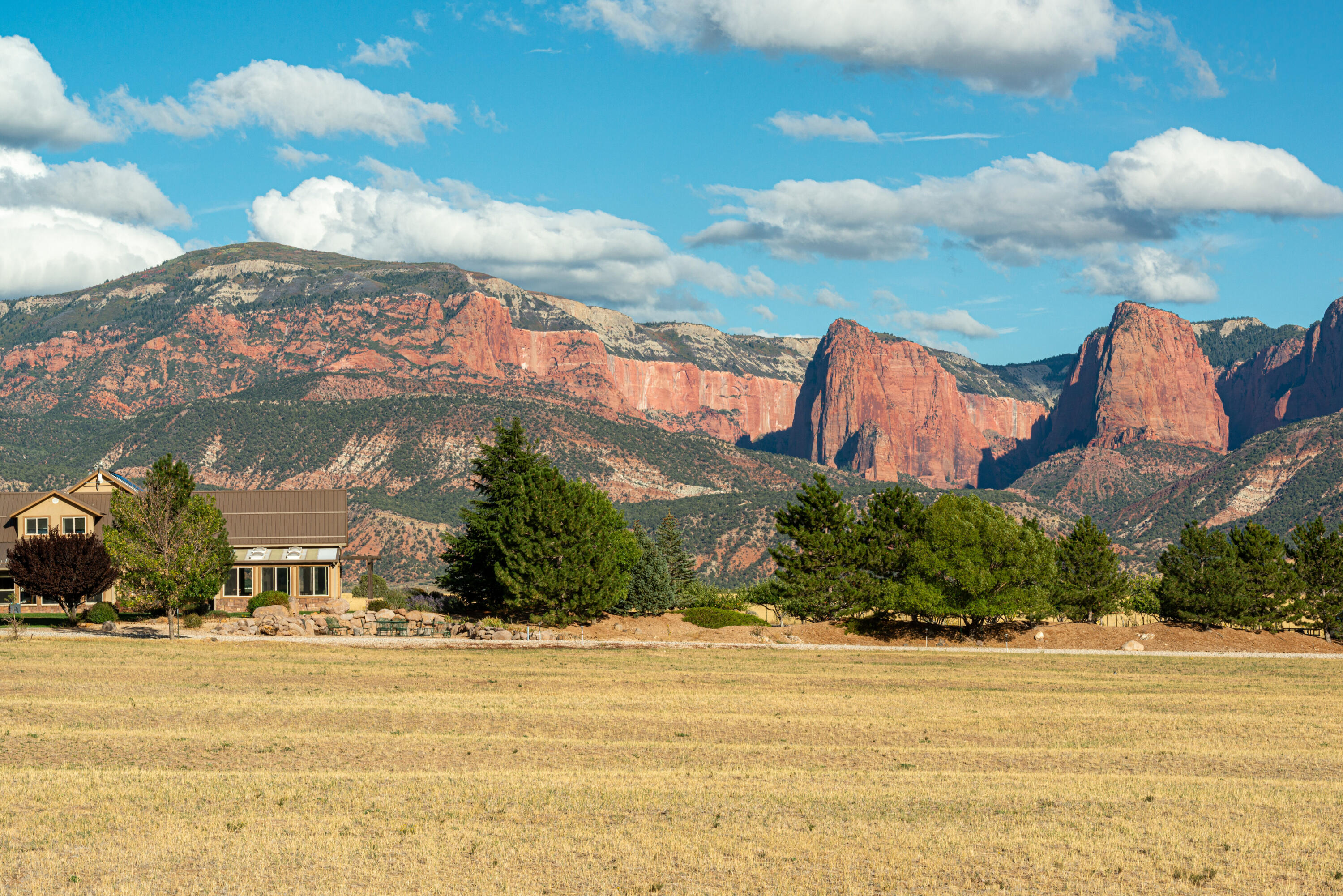 22-Acre New Harmony Estate Under $3M with Solar Infrastructure, Indoor Pool, Water Shares, Orchard & Kolob Views! Forget everything you know about high-maintenance relationships because I am the most dependable partner you will ever find in Washington County. I have been meticulously over-engineered by my current family to handle just about anything the world throws my way, from scorching summers to the kind of 'what if' scenarios that keep people up at night. While other houses are out there worrying about the grid, I am standing tall on twenty acres off Exit 42 in the 'new' New Harmony, grinning with my extensive solar infrastructure and ten-thousand-gallon freshwater tank. 

I am the ultimate quadruple threat: safe, secure, secluded, and self-sustaining, in my opinion of course. My owners have poured their hearts, souls, and a healthy amount of sweat into my pastures, creating a producing orchard and private ponds that make me feel like a lush oasis hidden against the backdrop of Kolob's red rock cliffs.

They have loved me well, adding personal touches to my ten bedrooms and ensuring my indoor pool is always ready for a midnight dip, but they have decided it is time for a new protagonist to take over the story. Whether you want to host an army of relatives in my five bathrooms or just hide away from the world and pretend you are the ruler of your own private kingdom, I have the sports court, the firepit, and 20 water shares to make it happen. 

I am not just a ranch in New Harmony; I am a rare, rugged, and slightly over-prepared sanctuary looking for someone who wants to live off the land without actually giving up the luxury of a master suite. My current family is ready for their next adventure, and they have left me in tip-top shape so you can start yours the moment you turn the key. You may want to change my 11 Bedrooms (6 Upstairs / 5 Downstairs)
5 Bathrooms (4 Full Bath / 1 Half Bath)
Separate and Spacious Laundry Room
4 Garage Doors for a Complete Pass-thru Experience
2 Wood-burning Fireplaces + Outdoor Fire Pit
Outdoor Fire Pit has Plumbed Propane to it
Land is Irrigated from Ponds with Underground Piping
Orchard is Watered from Either Sprinkler, Roof-water Runoff, or Ponds
Fully Fenced In
Perfect for Cattle and or Horses
Fully Fenced In Separate Area for Premium Garden 
Thermal Solar under Tile in Home
Solar Heated Indoor Pool
Solar on Home, Barn, and External Panels that Pivot
Salt Water Pool heated by Solar
Jacuzzi
Barn with Full RV Hook-ups
Well, with 1 Culinary Right
20 Water Shares with Harmony Canal Company 
Primary Suite is a 2-bedroom, 1 Full Bath, Full Kitchen, Living Room, and Balcony with a Separate Entrance
Gravel Drive from Gate Entrance to Home
Swamp Cooler
Gated Entrance
Orchard Offers Varieties of Apples as well as other fruit such as Peaches and Plums - Buyer to verify.
Large Septic Tank to Accommodate the Size of Home
10,000 Galloon Water Tank for Extra Storage
Cool Storage Under Home Accessible from Front Bedroom