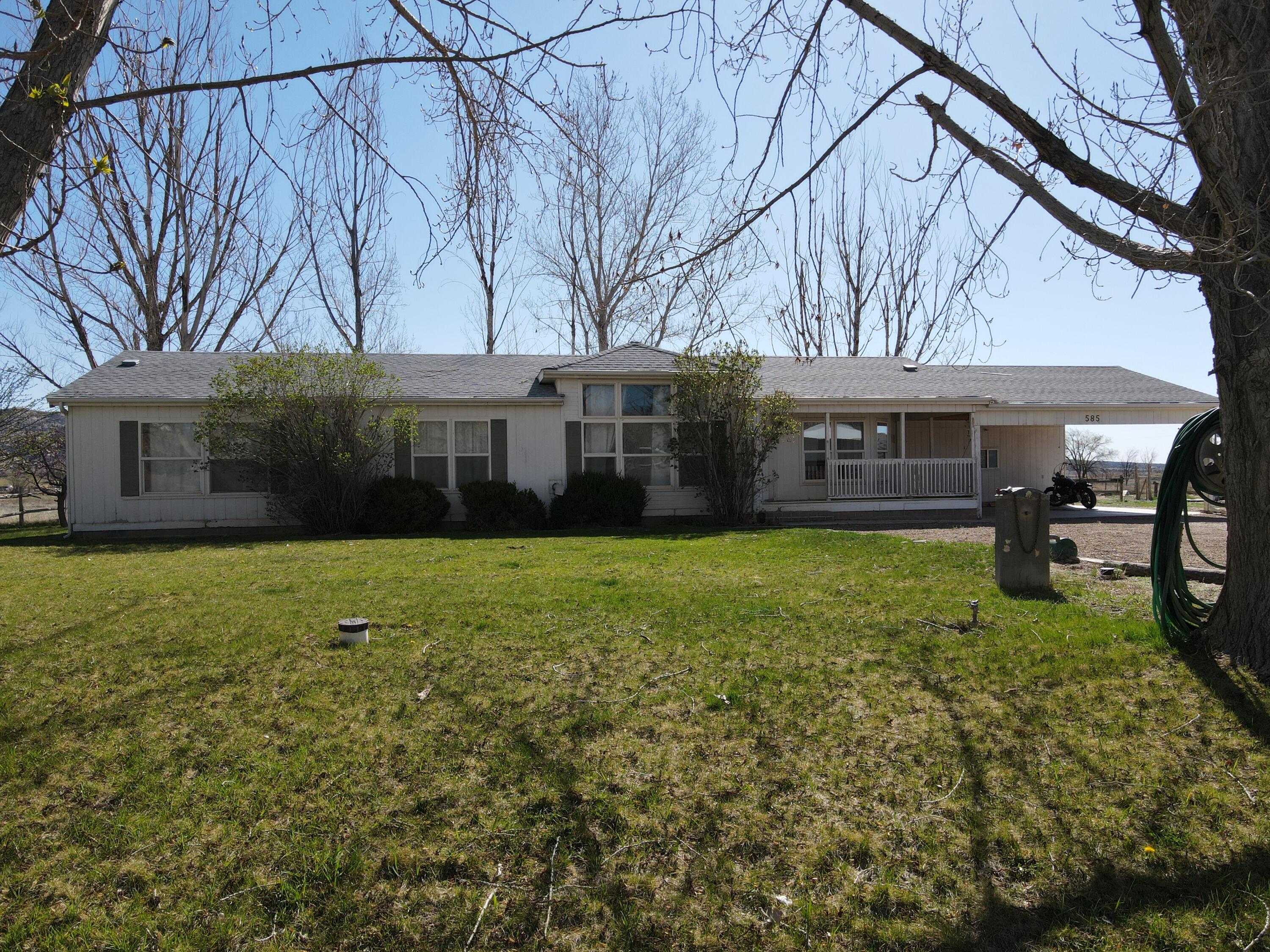 This comfortable single-family home sits on 1.5 acres in Escalante, surrounded by large mature trees for shade and privacy. Inside, tall ceilings and plenty of windows bring in lots of natural light and create an open, welcoming feel. The spacious kitchen and separate dining room make it easy to host family meals or gatherings with friends. The air conditioning unit is just one year old, keeping the home cool and efficient.
The property comes with 1.5 shares of irrigation water to help water its lawn and fruit trees, including cherry, plum, peach, and apricot. A powered workshop provides space for projects or storage, and an additional shed is perfect for yard tools or outdoor gear. 
If you've dreamed of wide open spaces or your own homestead, this property is ready for you.