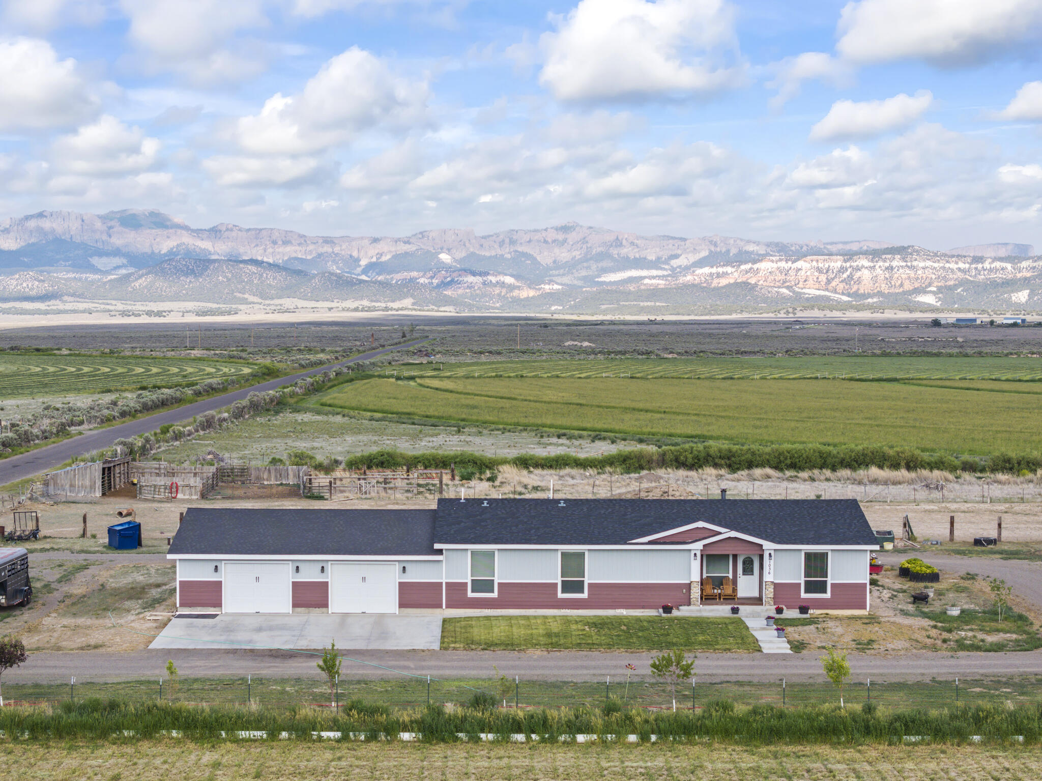 Bring the horses and other livestock to this beautiful home! Set on just under 17.5 acres across two fully fenced parcels, this spacious 2,400 sq ft single-level ranch home offers three bedrooms and three full baths, designed for comfort, privacy, and wide-open living. A circular-style driveway wraps around the home making it easy to load and unload livestock, providing easy access and a true estate feel with an attached garage with room for 4 cars that also have 3 exterior walls are wire for electrical and enough room for workbenches. It's also insulated and drywalled. The land package includes a productive 12.79-acre irrigated hayfield with gated entry, pipe irrigation, laser-leveled ground, and 45 dependable Long Canal water shares. The remaining 4.66 acres host the residence, offering peaceful seclusion and room to grow. Inside, the home features a bright, open floor plan with high-end finishes throughout, including stainless steel appliances, upgraded cabinetry, premium flooring, a built-in double oven with a large pantry. The primary suite includes a private bathroom and a spacious walk-in closet with two more bedrooms on the other side of the house and two more full bathrooms. Step outside to a generous 30' x 16' rear deck, perfect for entertaining or enjoying the surrounding landscape. The home is on a permanent foundation with a 4ft high crawl space. Easy access from the garage. Easy to move around in.
Additional upgrades include a Nuvo water softener and filtration system, generator-ready wiring, and full perimeter fencing with gated access. Property amenities include horse corrals, oversized 10' x 10' dog kennels, and an attached 40' x 40' insulated and drywalled garage with 220 power. Multiple shipping containers provide extra storage, and established fruit trees apple, peach, plum, pear, and cherry add to the property's self-sufficient appeal.
With ample space for additional structures, gardens, or recreational use, this property is ideally located just minutes from Bryce Canyon and Red Canyon, offering quick access to hiking, horseback riding, mountain biking, Panguitch Lake, and extensive off-road trail systems.