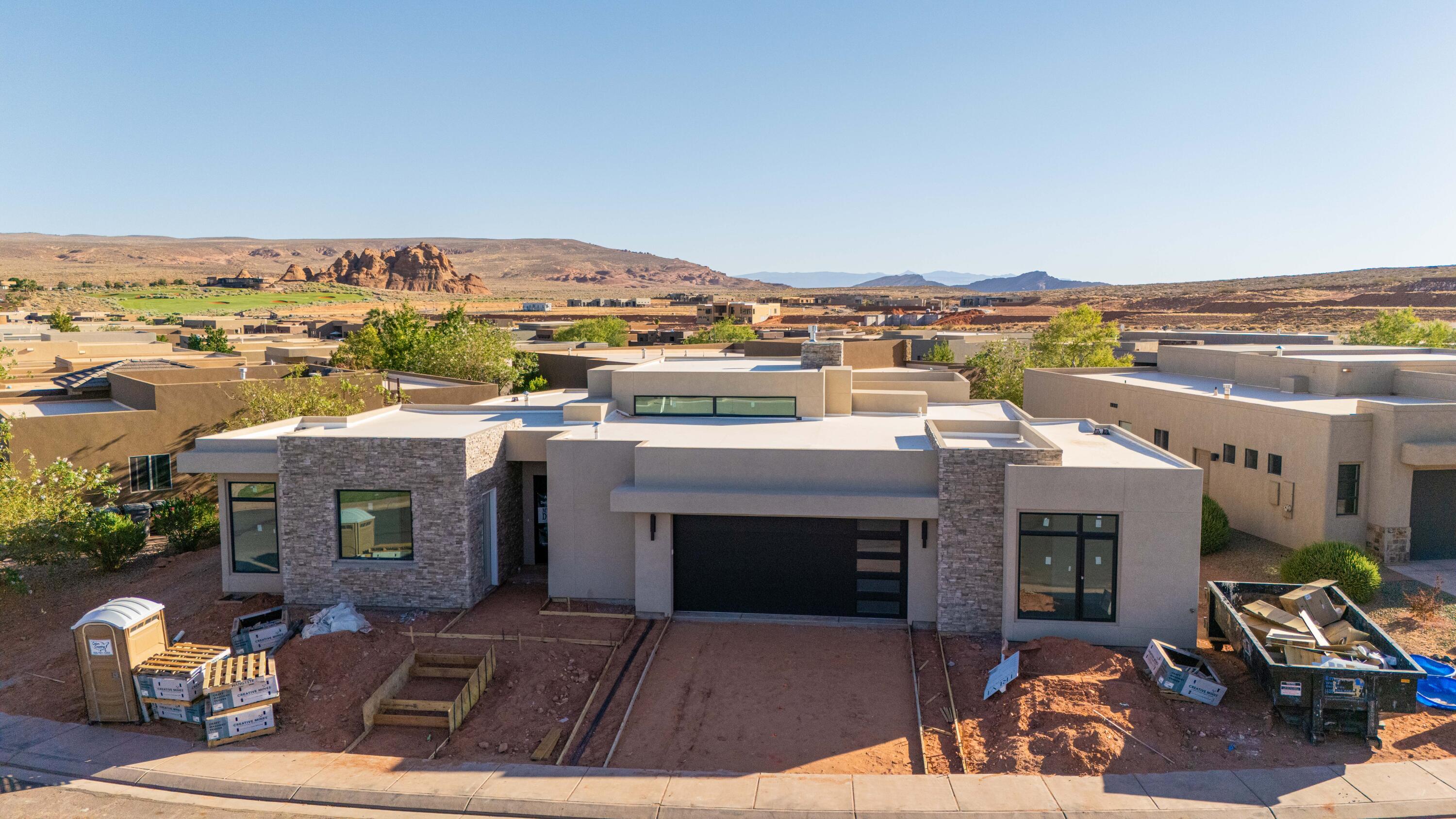 Estimated Completion: July 2026. Experience modern luxury in this stunning 4-bedroom home in The Dunes, featuring a sleek modern exterior, open-concept living spaces filled with natural light, and seamless indoor-outdoor flow to a private backyard with a pool. The spacious primary suite offers a spa-inspired bath with a freestanding soaking tub, while three additional bedrooms provide flexibility for family or guests. An attached casita with its own private entrance is perfect for visitors. Secure the home early and you'll have the opportunity to meet with the designer and personalize your finishes. Enjoy the added privacy, beautifully maintained surroundings, and elevated lifestyle that come with golf course living all in one of the area's most desirable communities. Residents enjoy access to the exclusive Sand Hollow Clubhouse and championship golf course, with discounted golf privileges, along with The Grille restaurant, seasonal pools, a fitness center, and nearby shopping. The HOA covers landscaping, maintenance of common areas, and access to the community pool and gym, plus the added peace of mind of hourly security patrol throughout the neighborhood.