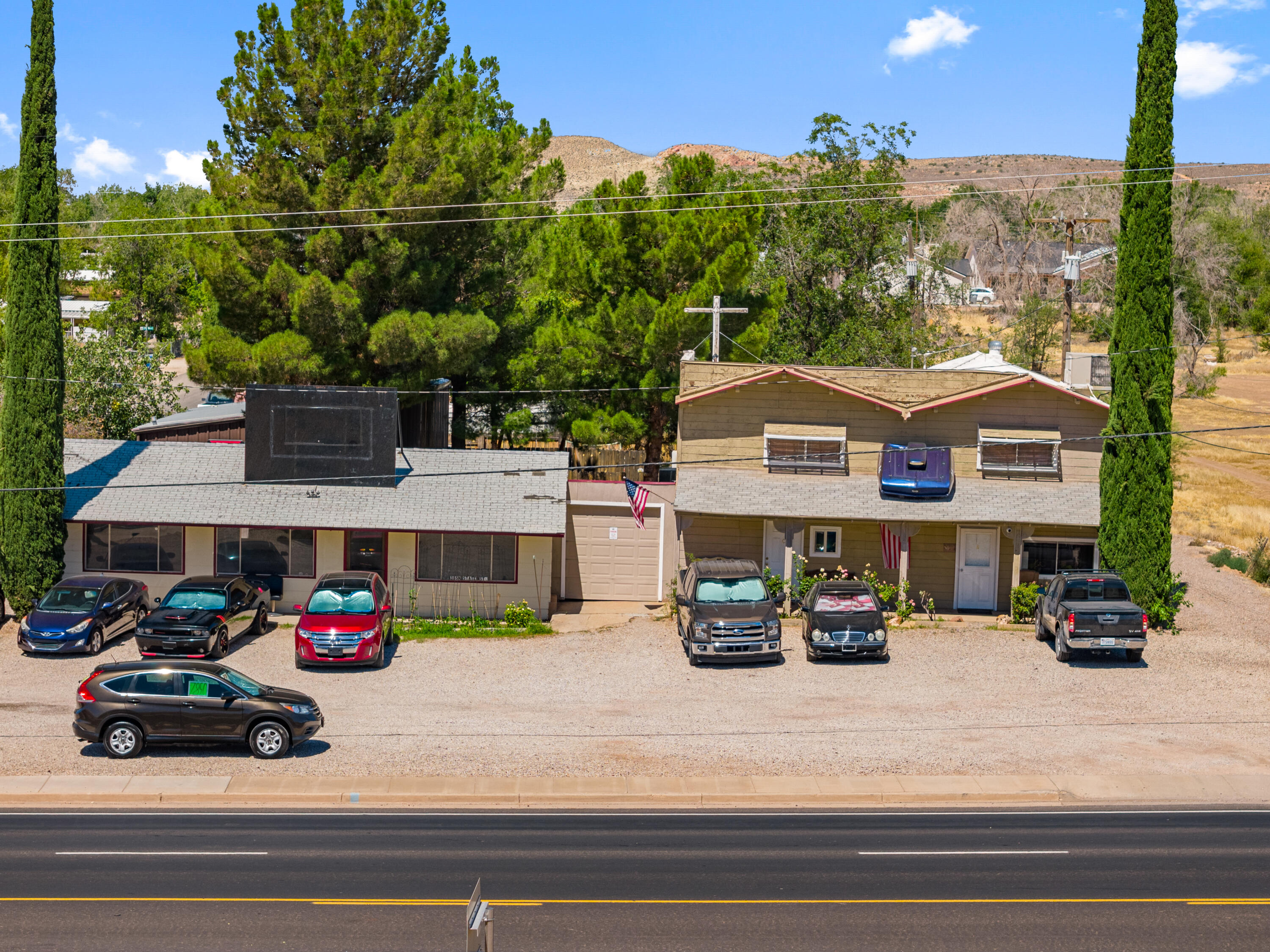 Rare Mixed-Use Opportunity on State Street! This highly visible property offers an exceptional combination of residential living, commercial potential, and outstanding workspace. Situated on a generous lot with excellent frontage and easy access, the property is ideal for business owners, investors, contractors, mechanics, hobbyists, or anyone looking for a live/work opportunity.

The property features a comfortable residence, extensive off-street parking, detached garages, and an impressive oversized metal shop with large overhead door, providing abundant space for vehicles, equipment, inventory, storage, or workshop use. The mature trees and fenced backyard create a private setting with patio space, gardens, and room to relax while still enjoying the convenience of a prime commercial corridor.

The mixed-use zoning opens the door to a variety of potential uses (buyer to verify permitted uses), making this property an excellent long-term investment with flexibility that is increasingly difficult to find. Whether you're looking to operate a business, generate rental income, store equipment, or simply enjoy the convenience of having substantial workspace at home, this property delivers.

Located just minutes from shopping, restaurants, schools, and major transportation routes, this unique property offers outstanding visibility, versatility, and future potential. Properties with this combination of mixed-use zoning, large shop space, generous parking, and a prime State Street location rarely become available.
Buyer to verify all zoning, square footage, permitted uses, and property information.
The main residence features spacious living areas with large picture windows, generous bedrooms, and plenty of room to personalize. Mature shade trees create a private backyard oasis complete with garden space, patio area, and room to relax or entertain.

One of the property's standout features is the expansive detached shop, providing excellent flexibility for projects, storag