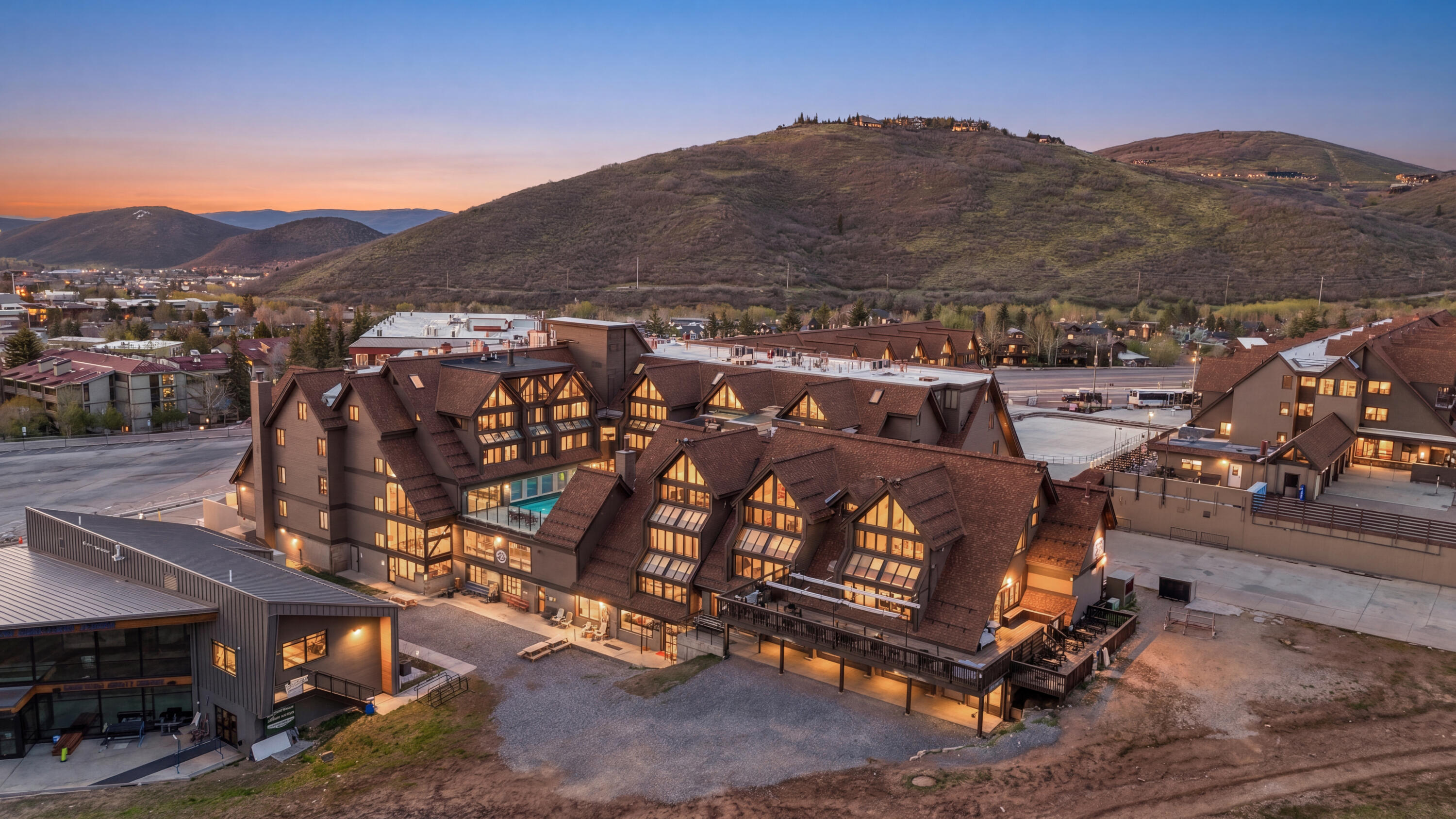 Located in the heart of Park City Mountain Village, this fully furnished and turn-key Resort Center condo offers an exceptional opportunity to own at the base of Park City Mountain. With four bedrooms, three full bathrooms, one half bathroom and 1,482 square feet, the residence is thoughtfully designed for comfort, convenience and year-round enjoyment.  The inviting great room is filled with natural light and features mountain-inspired finishes, a cozy fireplace and comfortable gathering space after a day on the slopes. A dining area with expanded windows captures an amazing view, creating a beautiful setting for meals, entertaining and relaxing with guests. The main level includes one bedroom en-suite, along with a convenient half bathroom. The condo comfortably sleeps eight guests and includes forced air, A/C, fresh new paint and a stackable washer and dryer.  One hall storage unit, if available, provide added space for skis, snowboards, gear and personal items. Step outside and enjoy exceptional ski access, with the ability to ski out to First Time, 3 Kings or Eagle chair lifts and ski back in with a short walk to the unit. Resort Center places you directly within the energy of Park City Mountain Village, surrounded by restaurants, shopping, ski shops and gear rentals.  Owners and guests enjoy Resort Center amenities, including a gym, year-round heated pool and hot tub, along with one unassigned underground parking space. Near Old Town and minutes from Main Street, this property is equally appealing as a vacation home, second residence or investment property. Nightly and long-term rentals are allowed, with the option to use your own property manager.  From winter ice skating and world-class skiing to summer activities including the Mountain Coaster, Alpine Slide, ZipRider™, mini golf, climbing wall and mountain biking, this condo offers four-season Park City living in a premier resort location.