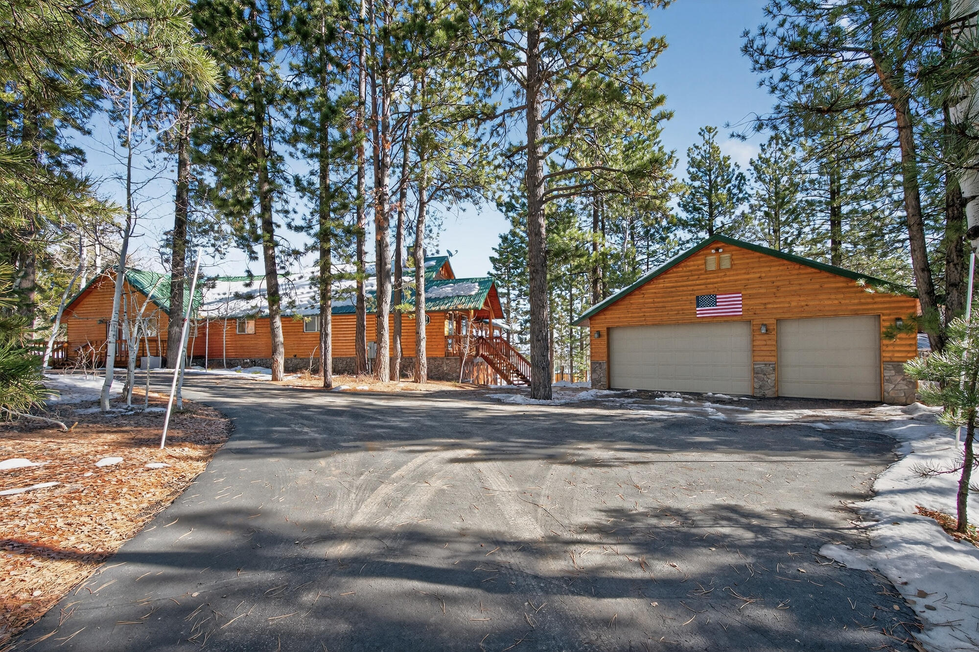 This 4,843 sq ft cabin, nestled on just over an acre next to BLM land and the Dixie National Forest, offers stunning views and privacy. With two bedrooms, a den, and an office that can be used as extra bedrooms, this cozy retreat includes 2.5 bathrooms, walk-in closets and a lot of storage! Modern comforts like two furnaces, A/C units, and two wood stoves ensure comfort, with remote-controlled heating for convenience. The main floor features a large kitchen and two spacious family rooms with high ceilings and big windows for breathtaking views and natural light. The primary bedroom has a private bathroom and a large walk-in closet, with easy outdoor access from the bedroom and adjacent den/office. Downstairs, find a versatile space for a living room, gaming area, gym, or bedroom, plus a second bedroom. Ample storage includes a 720 sq ft detached garage, a 144 sq ft shed, and more under the deck. A paved driveway and lush backyard with a sprinkler system make this cabin a perfect escape. It's a unique retreat that was meticulously taken care of. *Furniture is negotiable. Boards are on windows to protect from ice.