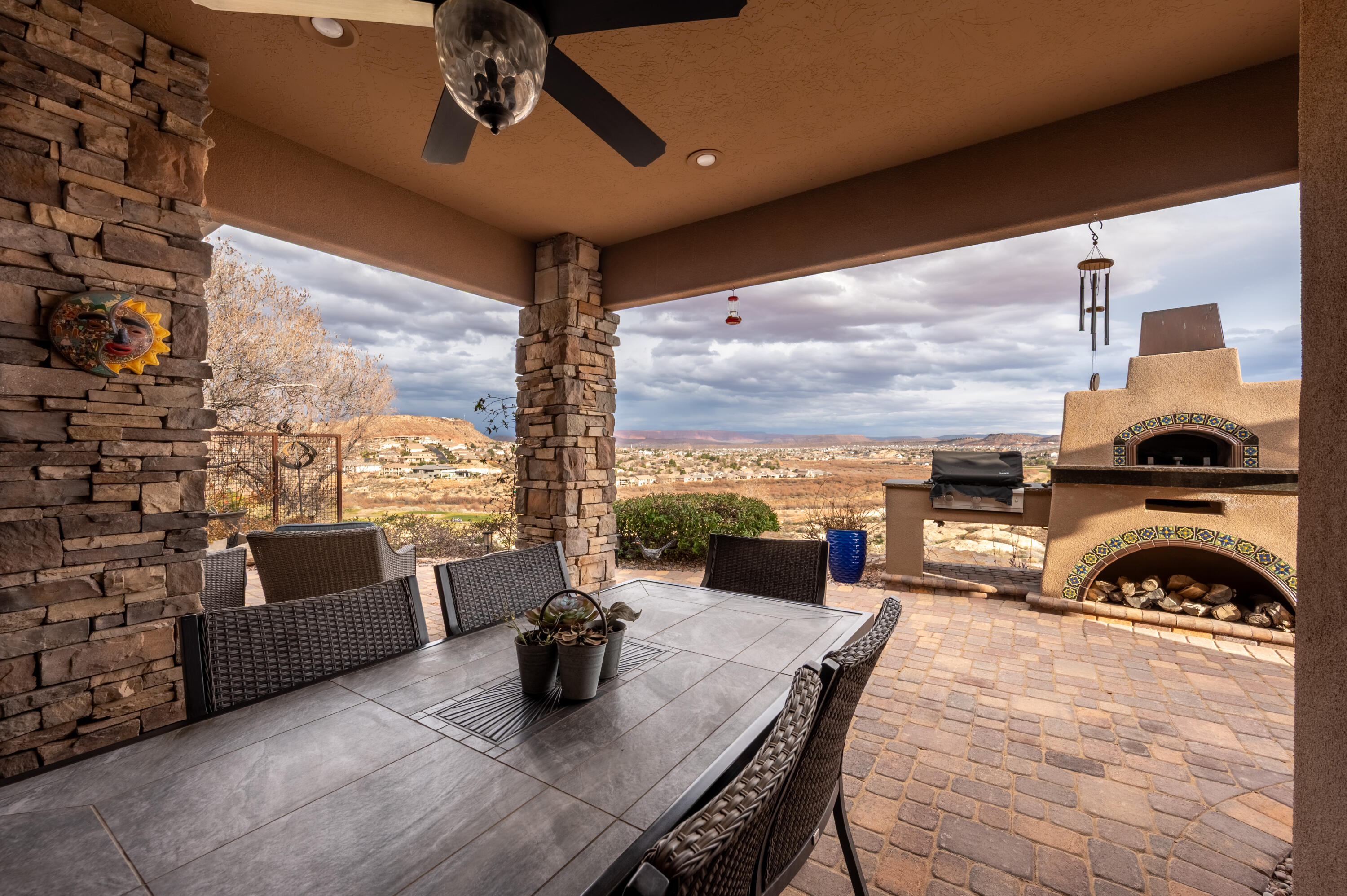 VIEWS, VIEWS, AND MORE VIEWS!
Located in the gated community of Sienna Ridge at Webb Hill, this exceptional home captures sweeping panoramic views of the St. George valley, the St. George Golf Course, and distant Zion. A north-facing wall of windows fills the home with natural light while showcasing the stunning scenery from multiple living spaces, including the den and kitchen. The backyard is designed for both entertaining and relaxation, featuring a pool positioned to take full advantage of the views, a built-in outdoor TV, and a custom pizza oven. Quality craftsmanship is evident throughout with detailed woodwork, including coffered ceilings, solid doors, and custom baseboards. The spacious kitchen offers abundant storage, a walk-in pantry, and an open layout ideal for gatherings. The primary suite features east-facing windows, a large walk-in closet, a garden tub, and a separate walk-in shower. Home features dual HVAC systems, separating the bedrooms from the main part of the home, providing efficient climate control and comfort. 
Additional highlights include a double-sided fireplace, generous storage and closet space, cobblestone accents, and a garage workspace area with a built-in workbench and tankless water heater. 
This property combines architectural detail, functional design, and remarkable views in one of St. George's most sought-after gated communities.