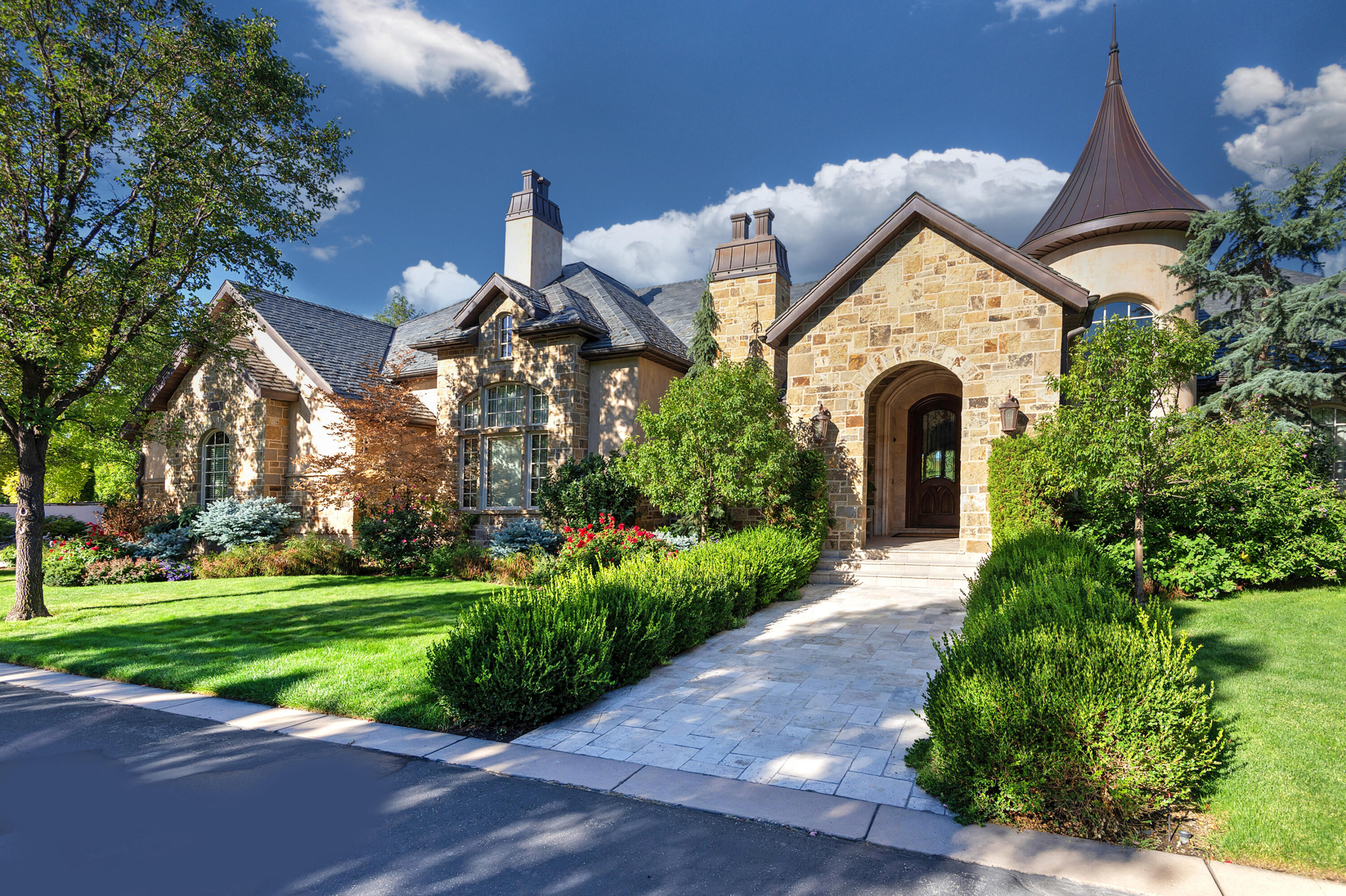 Step inside to the timeless elegance of this magnificent European-style estate, gracefully situated within one of Holladay's coveted gated communities. This distinctive architectural masterpiece is appointed with a generous five-car garage, a private elevator for effortless access, and a gracious entryway that truly promotes sophisticated living. Inside, two opulent master suites are linked by a hallway adorned with Crema Marfil marble, while the awe-inspiring two-story family room, featuring spectacular exposed beams and vast windows, flows seamlessly into a gourmet kitchen. The kitchen boasts Two Double Side by Side Fridges with Custom Cabinetry and Two Dishwashers. The lower level presents three additional bedroom suites, a relaxing sauna, a shower, and a dedicated, state-of-the-art theater room for optimal entertainment. Wander outside to a serene, covered deck overlooking a vibrant garden area complete with stately mature trees, exquisite colorful shrubs, and soothing tranquil waterfall. Enjoy peace of mind with a Backup Generator. With its updated, move-in ready condition and prime location just minutes from the 215 freeway, downtown, and ski resorts, this enchanting residence is a true must-see! Square footage is provided as a courtesy only. Buyer is advised to obtain an independent measurement and to verify all information.