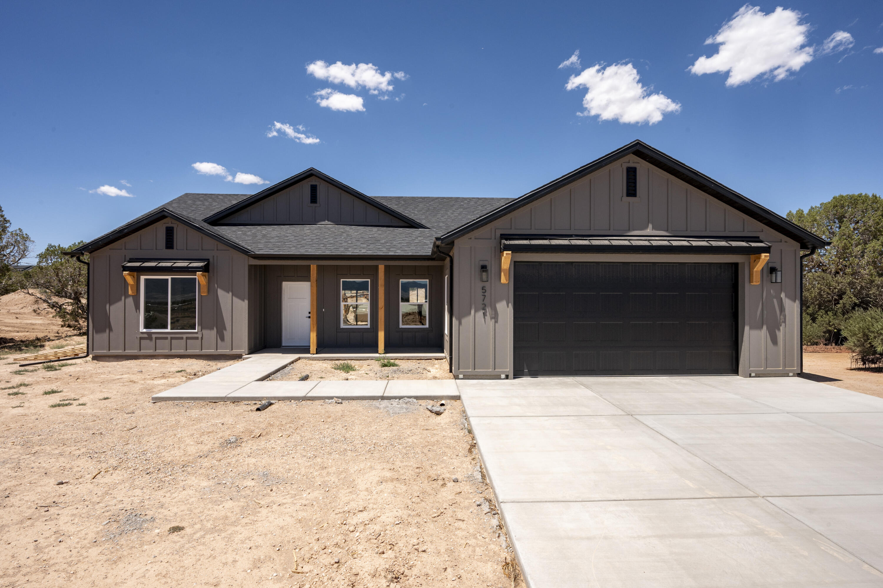 Enjoy country living in this beautiful new construction home situated on 1.25 acres in a peaceful rural setting with animal rights and plenty of room to spread out. This 3-bedroom, 2-bath open concept home offers quality finishes throughout, including custom cabinets, granite countertops, durable LVP flooring, and beautiful custom details. The spacious primary suite features a stunning tile shower with double sinks, double shower heads, and a relaxing soaker tub. You will love the rough sawn exterior details, board and batten Hardie siding, large covered patio and stucco exterior. Bring your RV, trailers, toys and animals-there is ample parking and space to create your own mini farm or hobby property! Comes with .5 acft of water on a shared well.