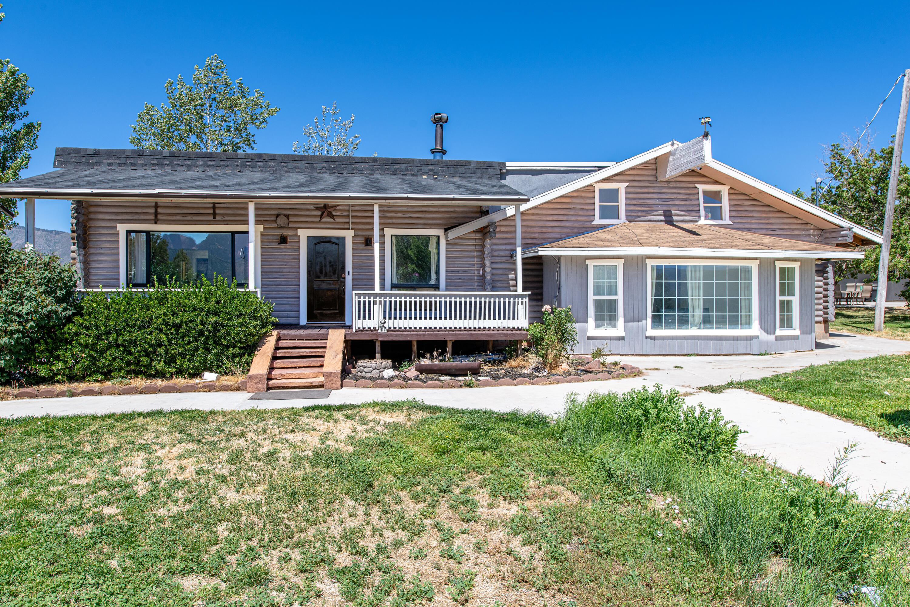 Experience the beauty of Southern Utah from your own private retreat. Nestled on 7.5 scenic acres with panoramic views of the Kolob Mountains, this 4-bedroom, 2.5-bath split-level home offers 2,475 sq. ft. of rustic charm, includes a cozy wood stove and warm log construction throughout. Improvements include new HVAC mini split system for each room, new flooring and baseboards. This property is ideal for those seeking a full-time residence, vacation retreat, or hobby ranch. True self-sufficiency awaits with a private well, valuable 2.5-acre feet of water rights, and a septic system, plus a detached workshop, storage shed, and ample RV parking. Enjoy horse privileges, mature fruit trees, and plenty of room to expand. Located just minutes from Zion National Park, Cedar City, and St. George, this rare property offers the tranquility of country living with convenient access to year-round recreation. Whether you're looking for a horse property, homestead, or simply a place to enjoy breathtaking Southern Utah sunsets, this one-of-a-kind opportunity is ready to welcome you home. Schedule your showing today--properties like this don't last.