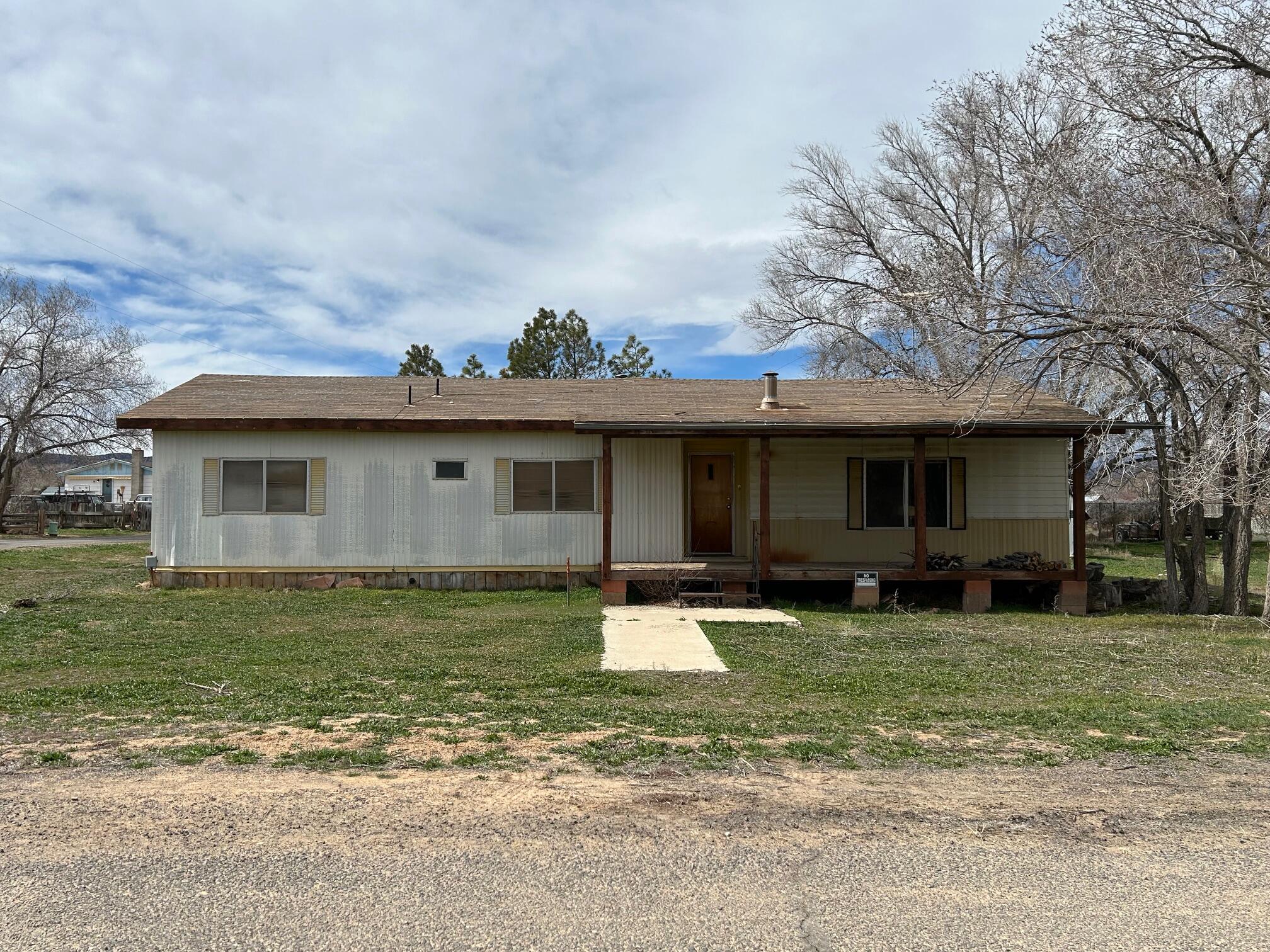 Huge price reduction! Great value for a stick built 2 car garage on nice 1/4 acre lot with views, shed and mobile home. Great starter home or easy recreational getaway in the Heart of the Escalante Grand Staircase Nat'l Monument. Minutes from Mountains, slot canyons and world-class hiking. Turn key with all furnishings & appliances included. Home was updated in the 90's, large primary bedroom with spacious bathroom and closets.  Wood stove and covered back deck off the kitchen for country gatherings. Situated on a large corner lot. Needs a little TLC - Perfect opportunity to enjoy the slow pace of life at an affordable price!