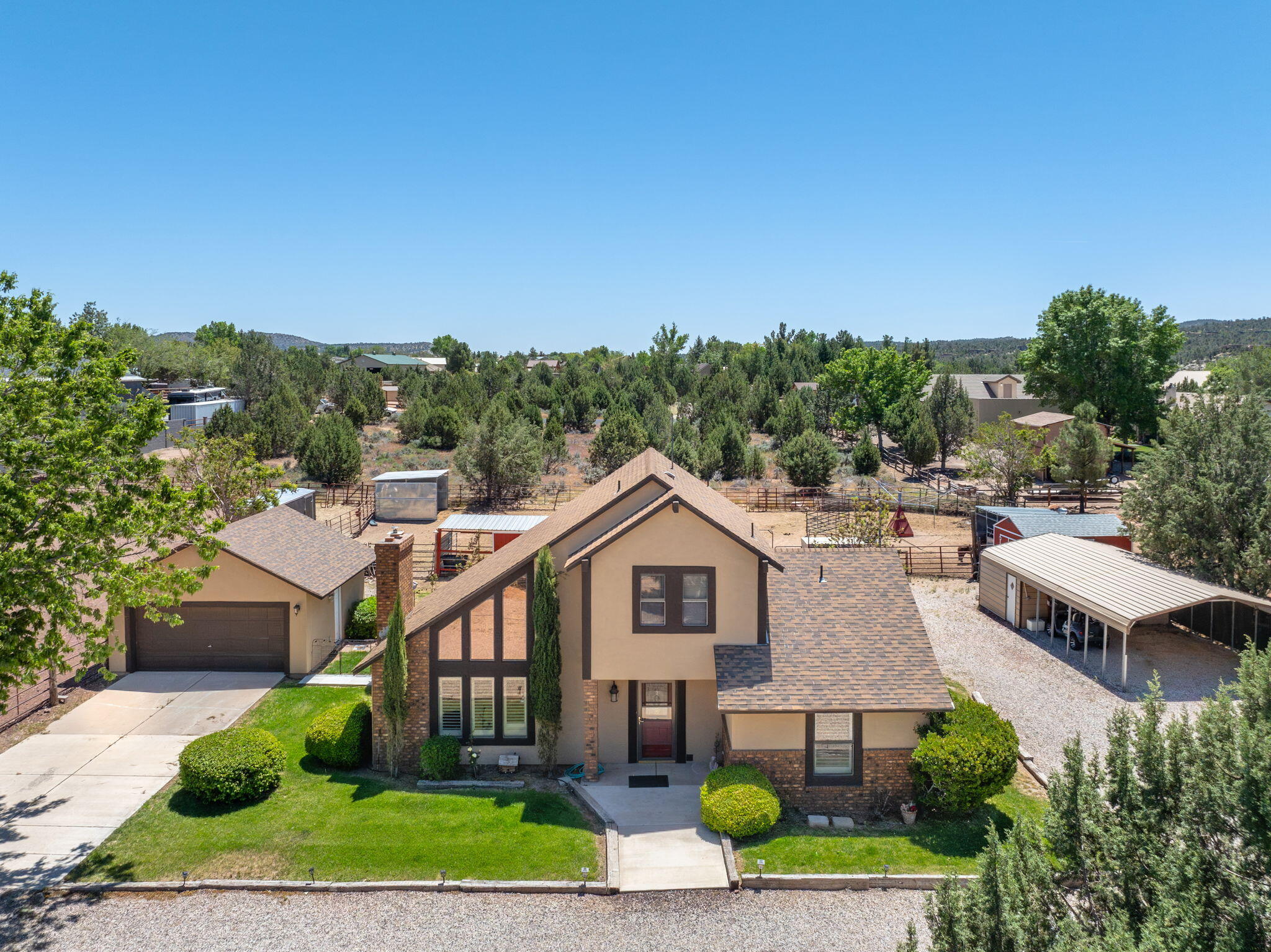Escape to Dammeron Valley with this charming horse property situated on a spacious 1-acre lot surrounded by stunning mountains and desert views. Featuring soaring vaulted ceilings, abundant natural light and warm wood accents. The kitchen showcases granite countertops, stainless steel appliances, and bright views of the property. Outside, the property is fully equipped for animals, hobbies, and outdoor living with fenced corrals, pasture space, a tack room/small storage barn, and both uncovered and covered RV parking with plenty of room for trailers, toys, and equipment. Mature trees provide shade and privacy while the expansive lot offers endless possibilities for gardening, recreation, or additional projects. Enjoy the quiet rural lifestyle with no HOA while still being just a short drive to St. George amenities, hiking, and outdoor recreation.